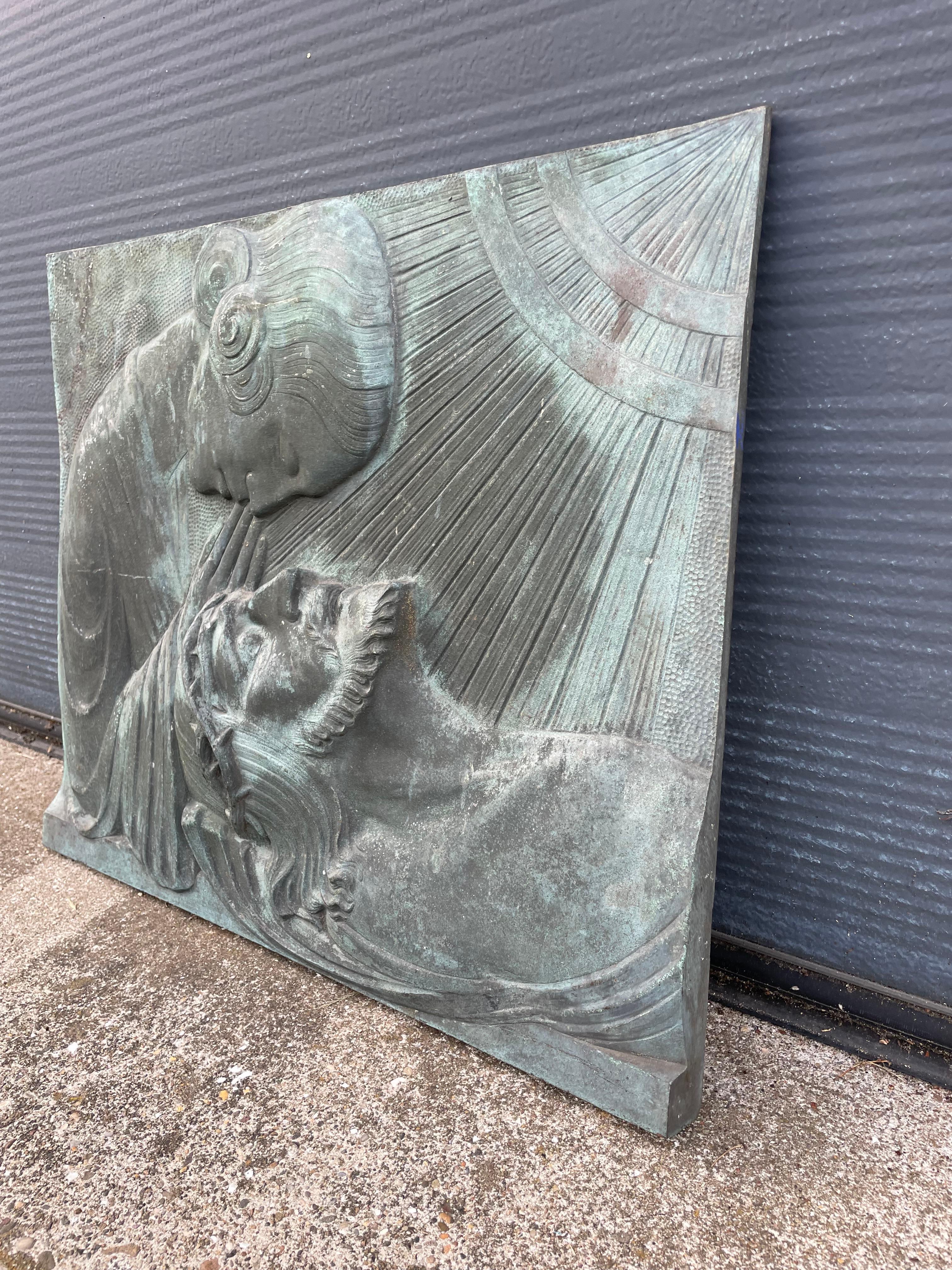 Stunning Art Deco pieta sculpture by Silvain Norga with best ever patina.

This large bronze plaque depicts the Virgin Mary praying over the body of Jesus Christ after the Crucifixion. The typical Art Deco hairstyle of Mother Mary and the Holy light