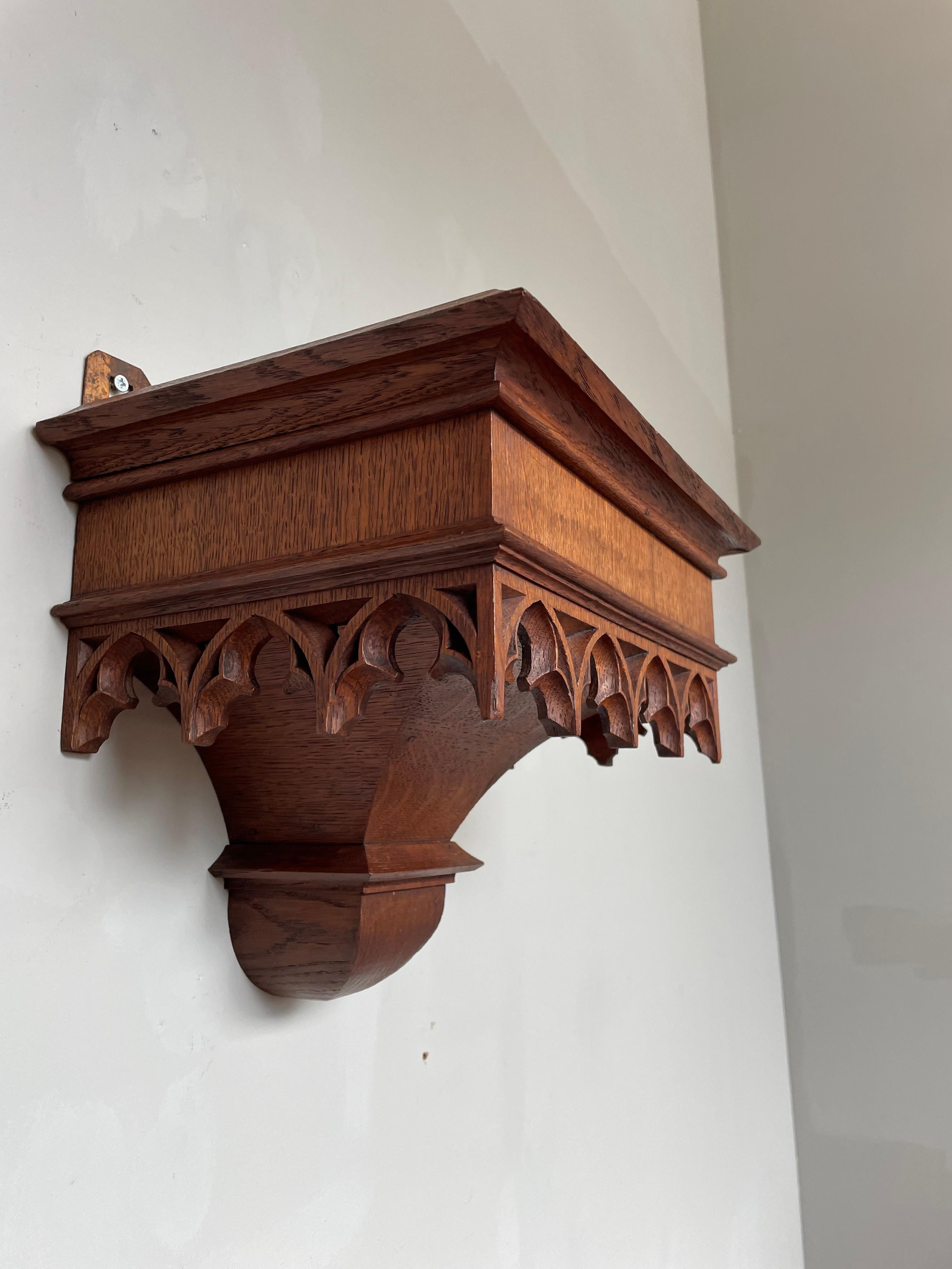 Wonderful and perfectly hand carved, pure Gothic Revival, church wall bracket.

This all handcrafted, Gothic Revival wall bracket has the most wonderful shape and a striking patina. The deeply carved, church window design, carved elements all around