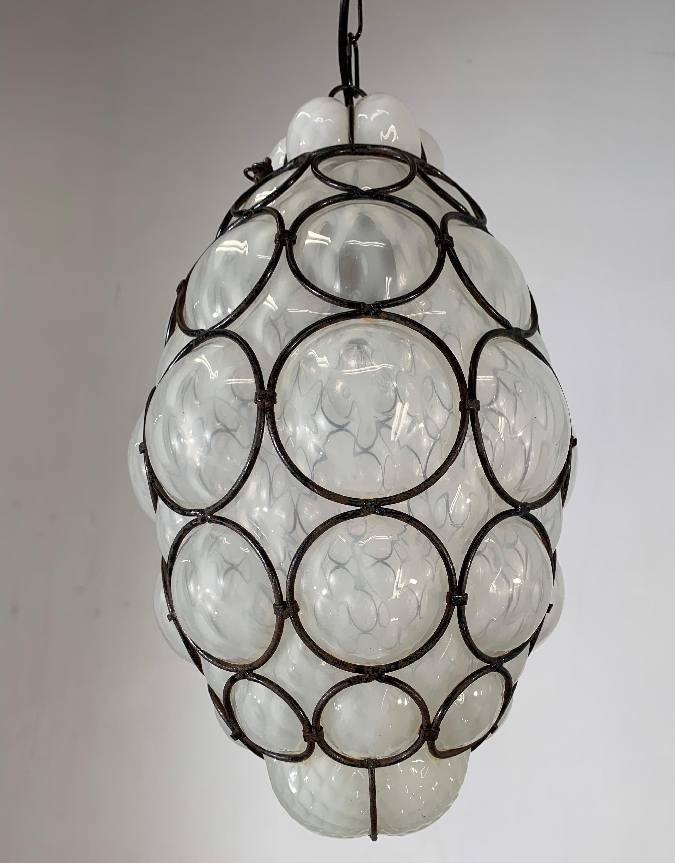 Early 20th century, Italian craftsmanship pendant. 

This stylish single light pendant is beautiful in shape and the mouth blown, white/blue tinted glass is in excellent condition. The opalescent quality of this fixture combined with its