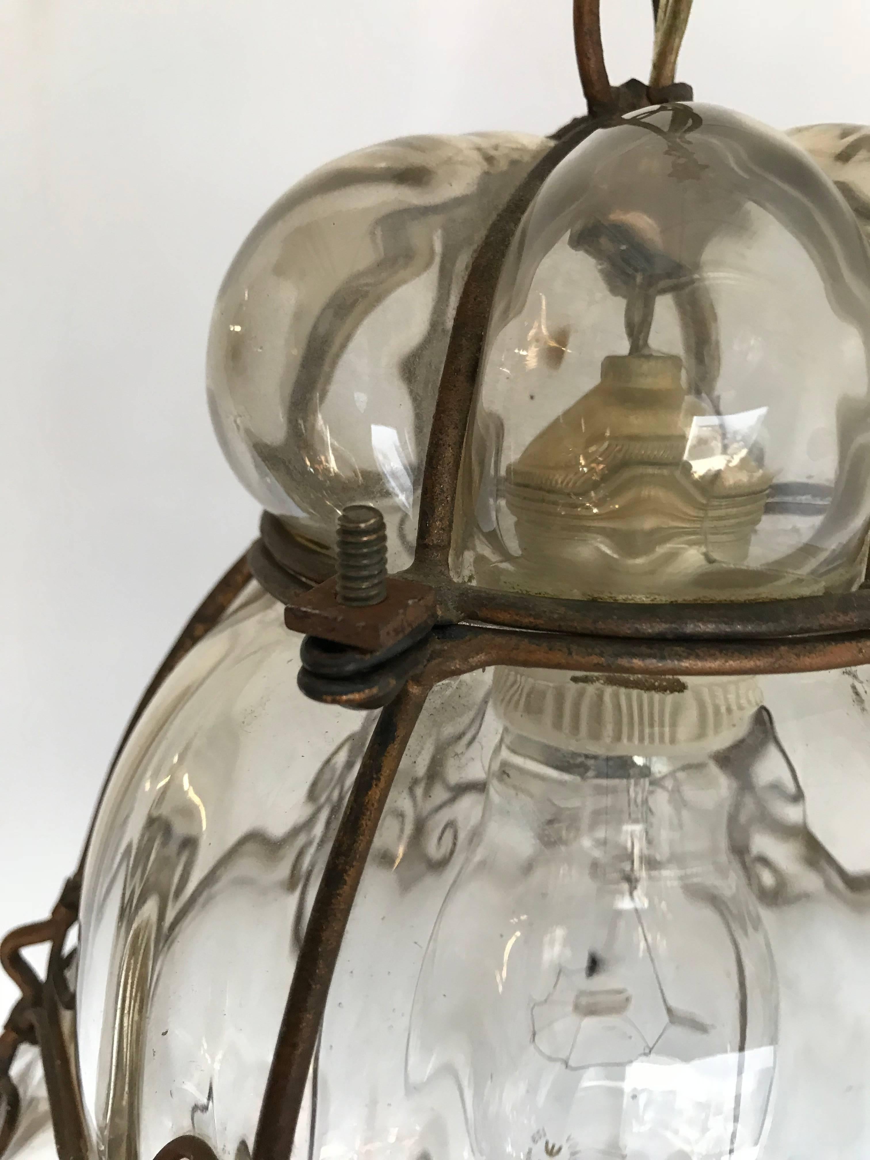Early 20th century, Italian craftsmanship pendant light 

This stylish Murano light pendant is beautiful in shape and the mouth blown, soft green tinted glass is in excellent condition. It comes with the original chain and metal canopy and the bulb