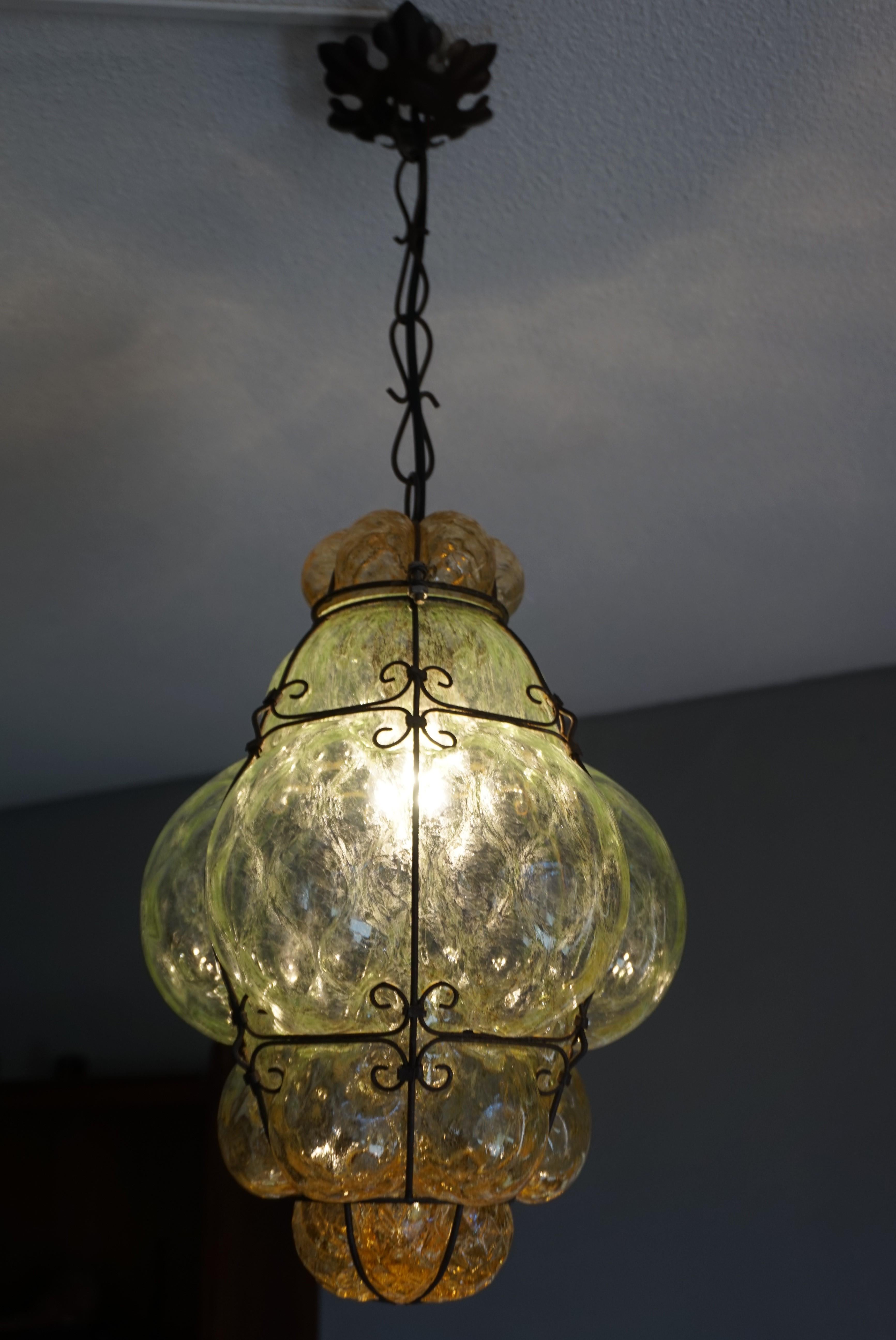 Early 20th century, Italian workmanship pendant light.

This stylish Murano pendant light is beautiful in shape, ideal in size and the mouth blown, green and amber colored glass is in excellent condition also. Over the years we have sold many rare