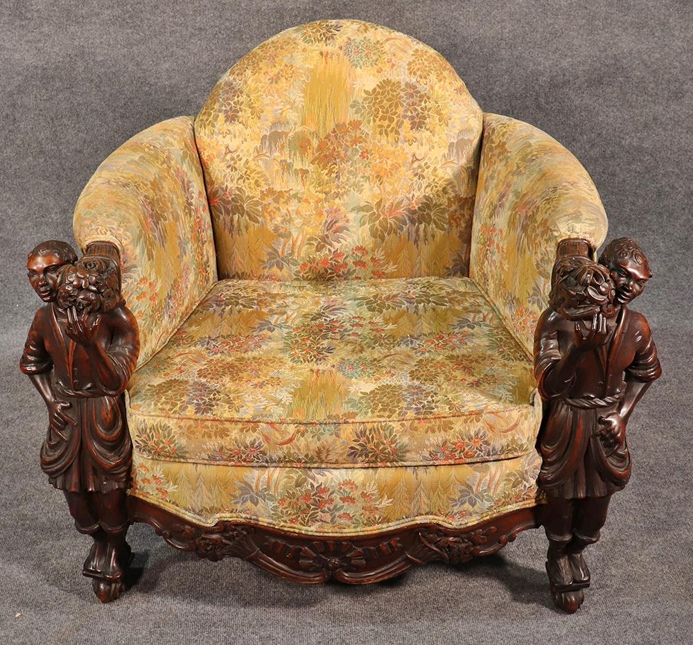This is an exceptional antique Andrea Brustolon style figural carved walnut club chair with tapestry upholstery.