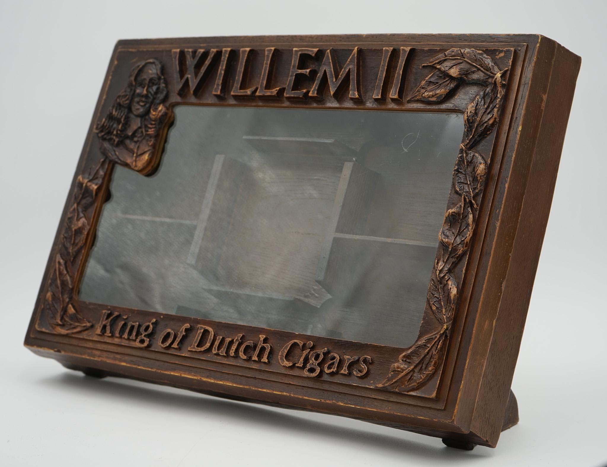 
Antiques of London



A rare oak-glazed shop counter display cabinet made for the Anglo-Dutch Cigar Co. Ltd., branded Willem II – King of Dutch Cigars. This cabinet would have originally been placed on the counter of tobacconists to display cigars