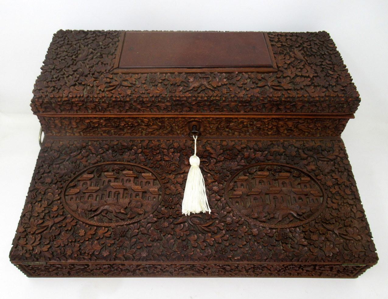 Stunning Anglo-Indian Bombay hand carved sandalwood writing slope of generous proportions and outstanding quality, mid-19th century.

The exterior hand carved profusely with animals and birds amongst scrolling foliage, the upper dome shaped