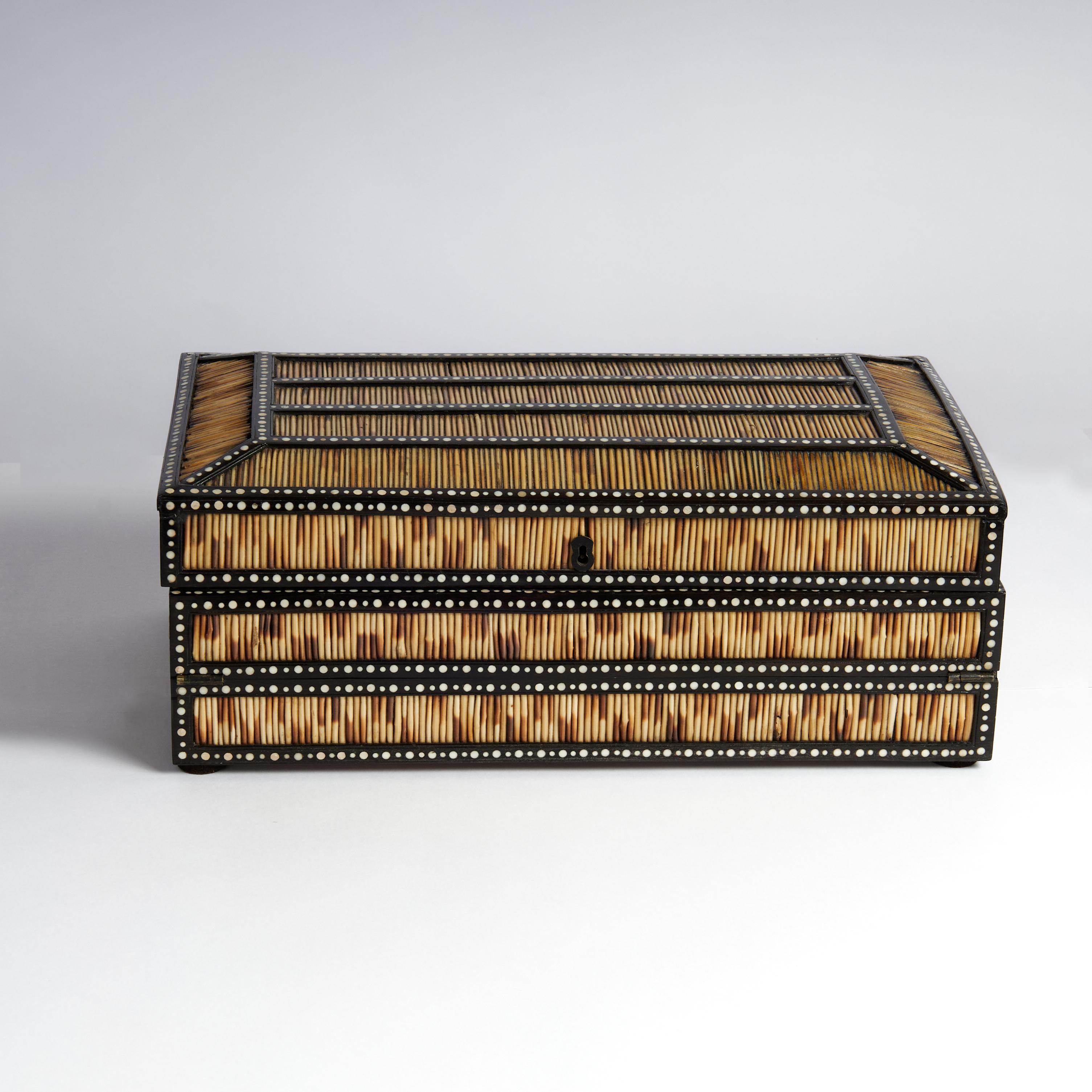 Impressive antique Anglo Indian lap top desk crafted in quills and ebony decorated with bone dots. The surprising interior has multiple components featuring a felt writing surface, nooks, boxes and hidden compartments all with elaborate floral and