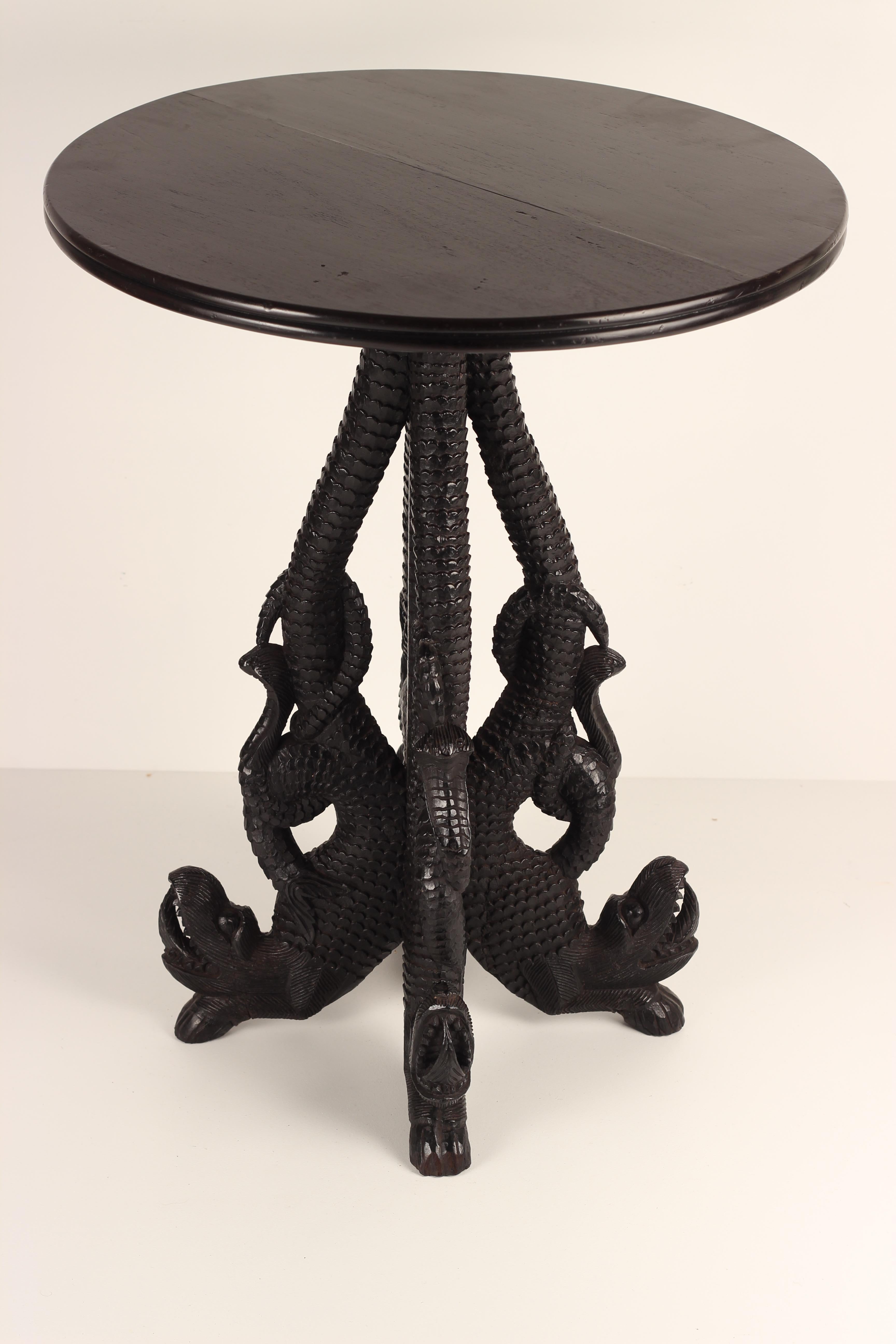 Extensively carved and detailed 19th Century Anglo-Indian Rosewood table. Four dragons form the stem and the feet of the table. We believe the top to be a later edition and feel that it would benefit from a bespoke marble top as a replacement to the