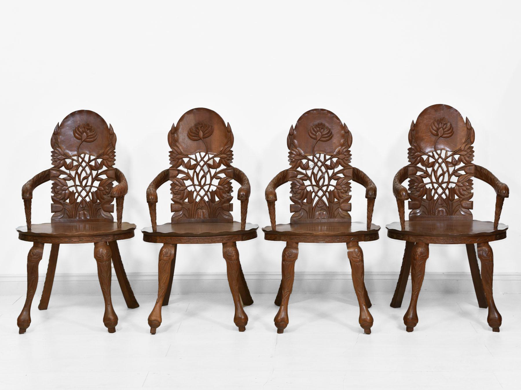 A superb decorative set of four carved walnut Anglo Indian armchairs and matching extending dining table. Circa 1920.

Handmade in solid walnut, with hand shaped table top and seats, having a pie crust edging. The chairs have carved lotus leaf