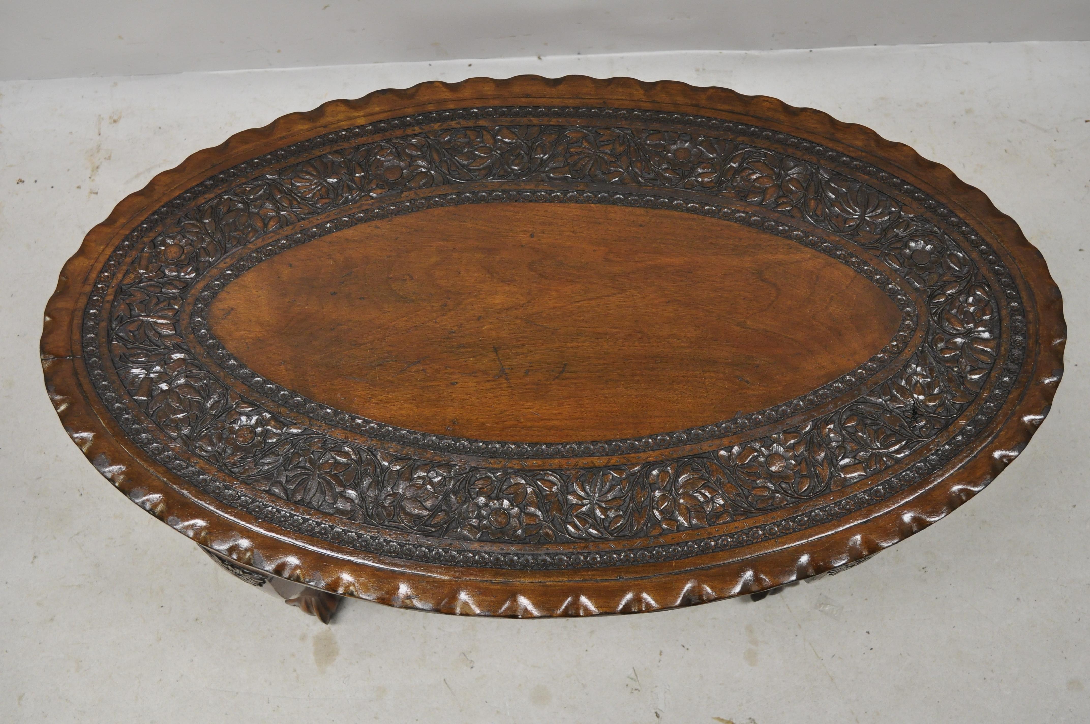 Antique Anglo Indian Georgian small paw feet oval mahogany coffee table (A). Item features ornately carved oval top, solid wood construction, nicely carved details, carved paw feet, great style and form, circa early 1900s. Measurements: 17