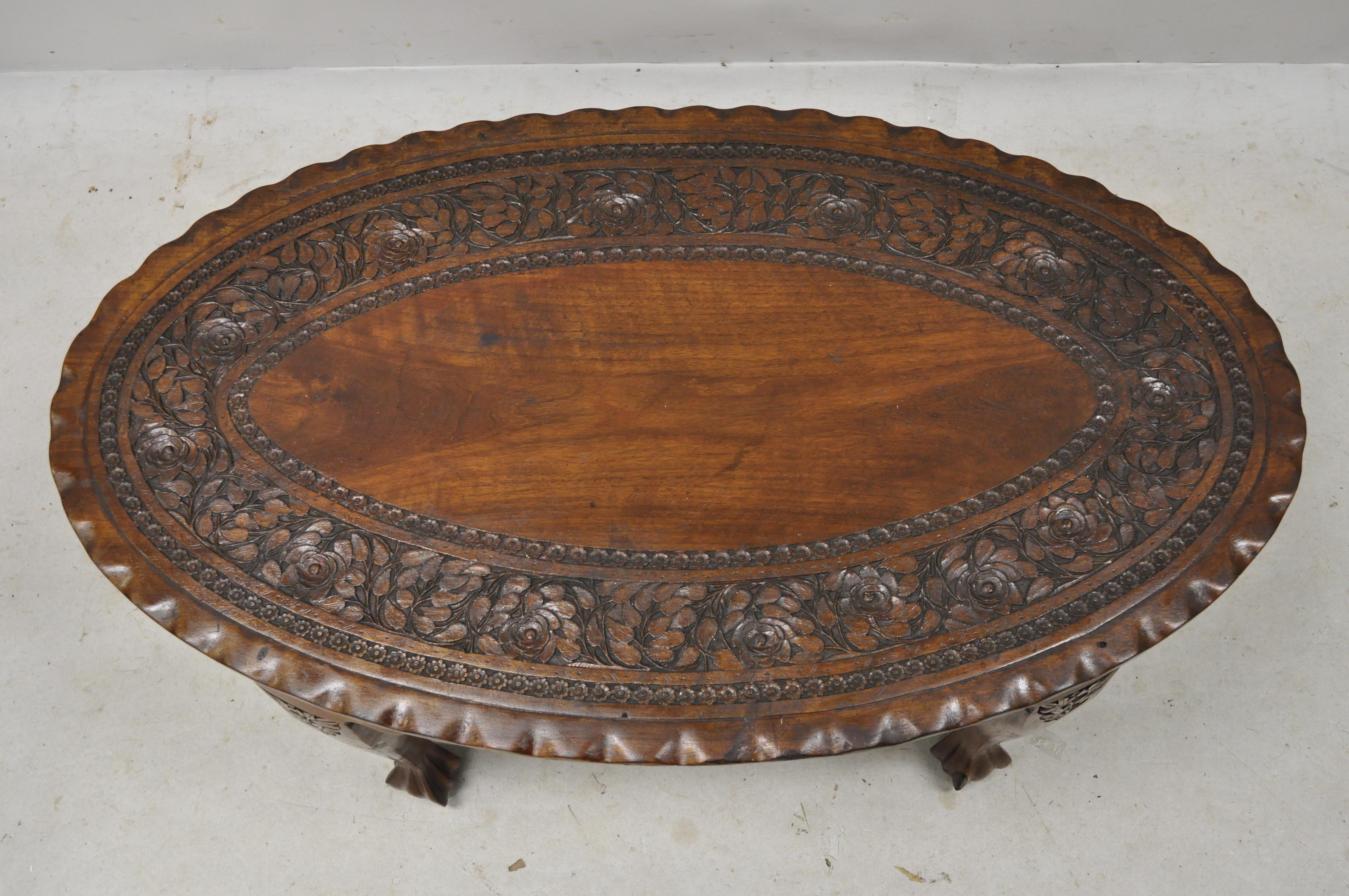 Antique Anglo Indian Georgian small paw feet oval mahogany coffee table (B). Item features ornately carved oval top, solid wood construction, nicely carved details, carved paw feet, great style and form, circa early 1900s. Measurements: 17