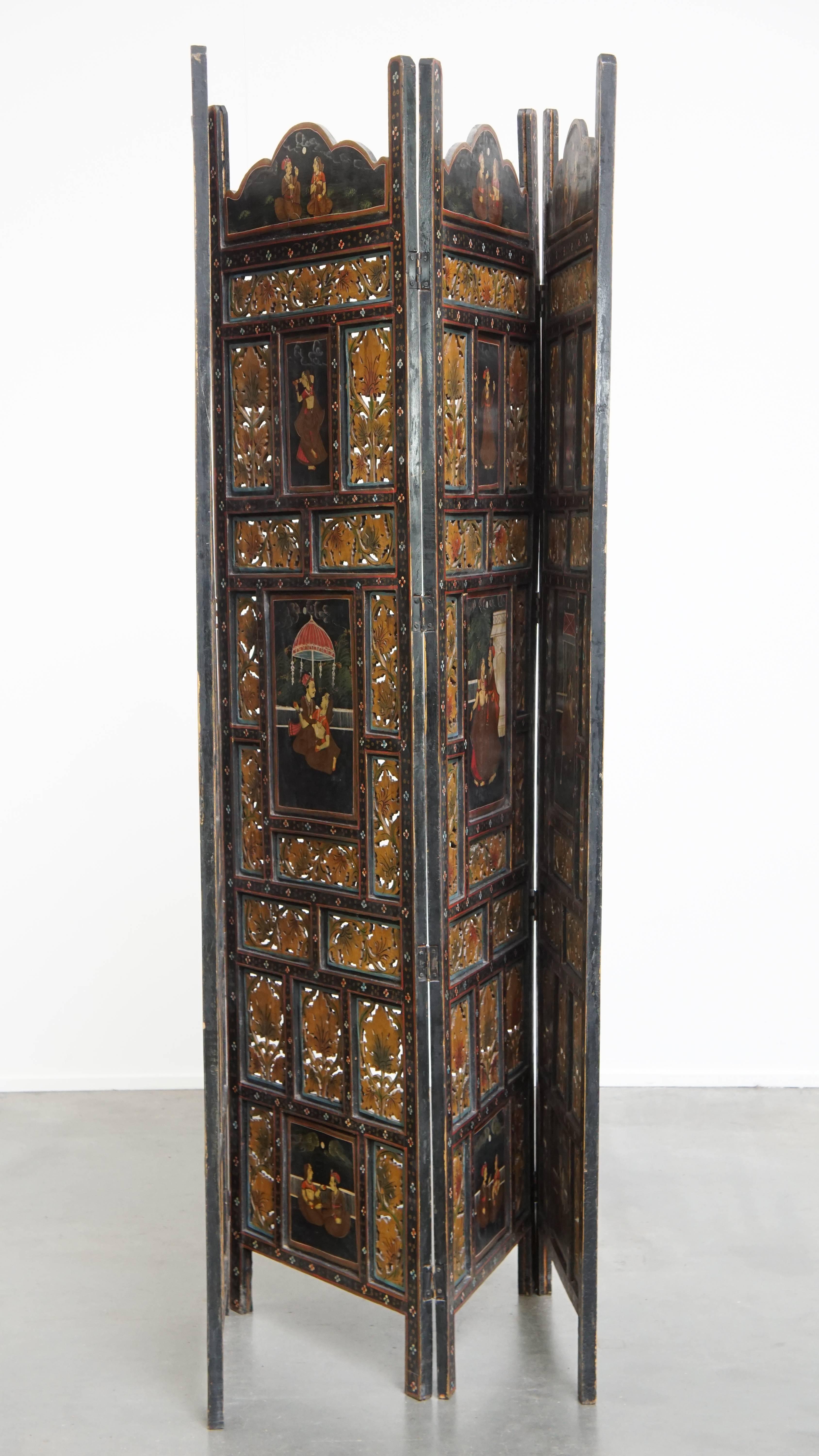 Offered for sale: this colorful antique Anglo-Indian hand-painted wooden room divider from the late 19th century. This unique, hand-painted antique Anglo-Indian wooden screen is a true eye-catcher in any interior. Dating from the late 19th to early