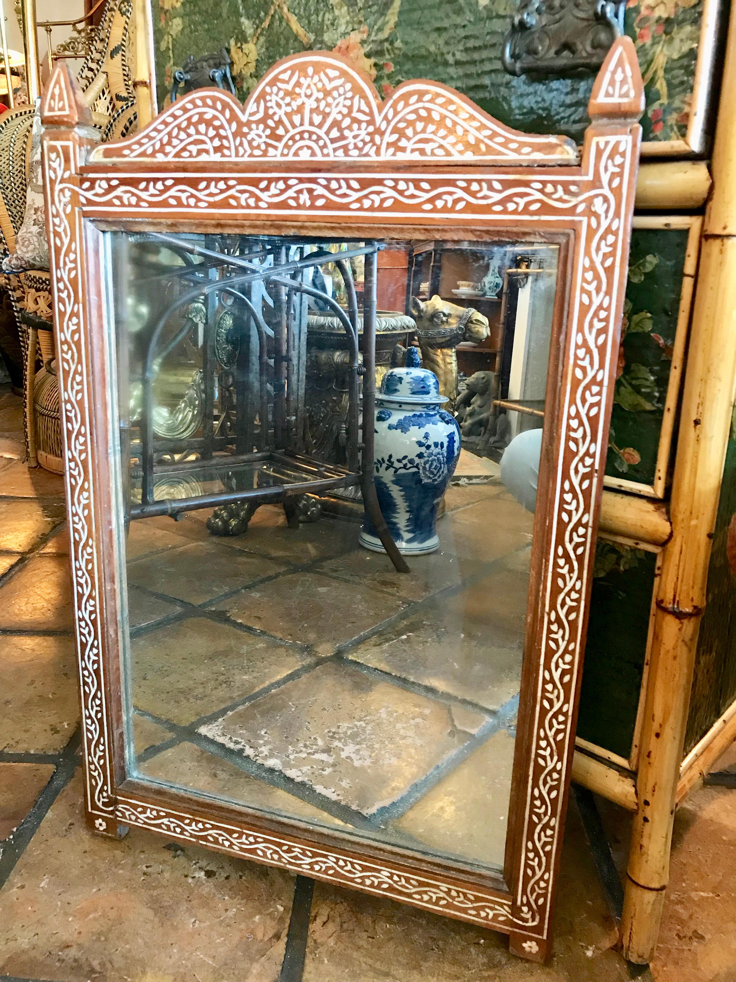 Extensively inlaid hard wood. A nice accent mirror,
late 19th century.