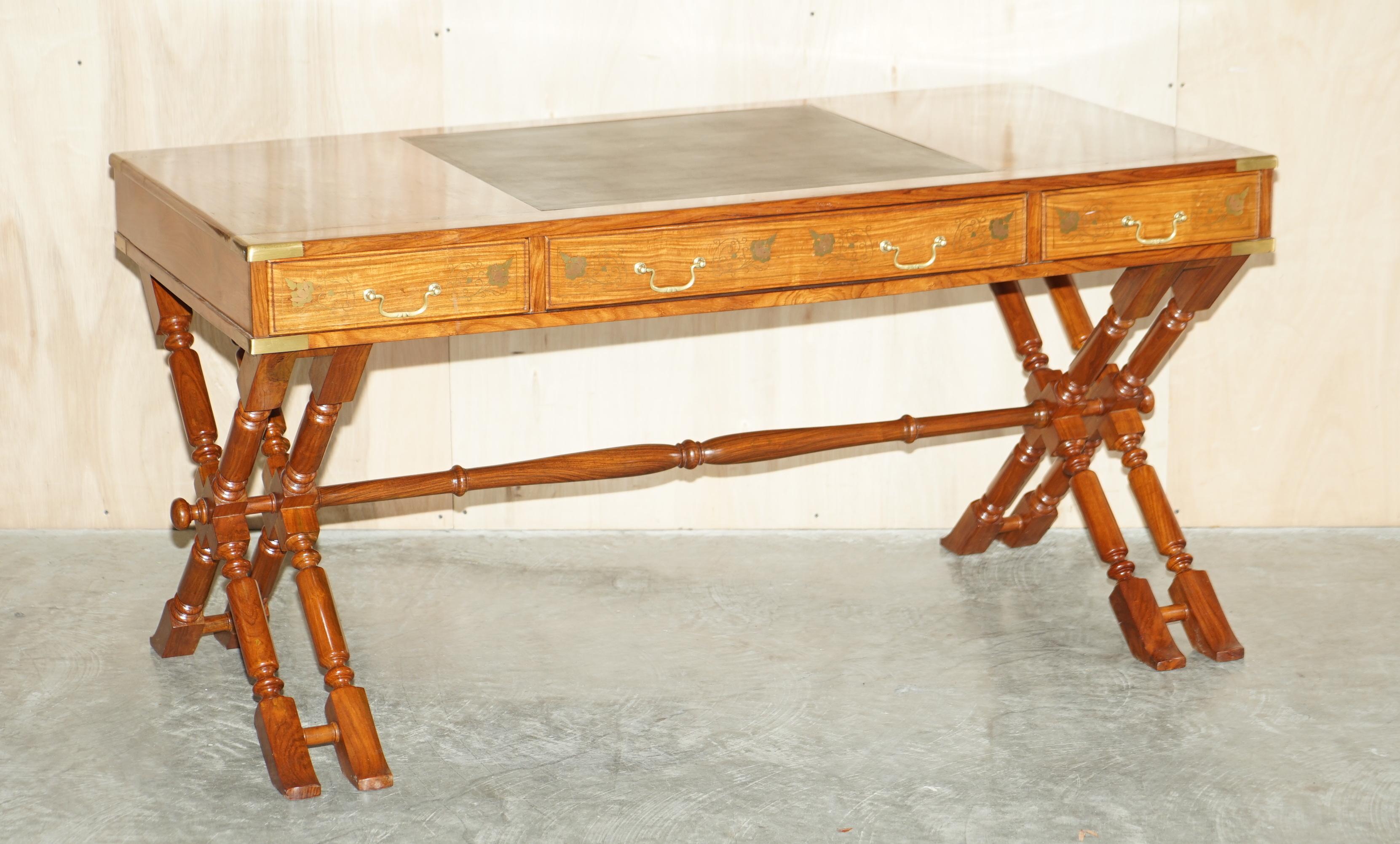 We are delighted to offer for sale lovely vintage Anglo Indian Rosewood with ornate brass inlay Campaign trestle desk with matching directors armchair.

A highly decorative and well made pairing, the desk is based on an antique campaign piece