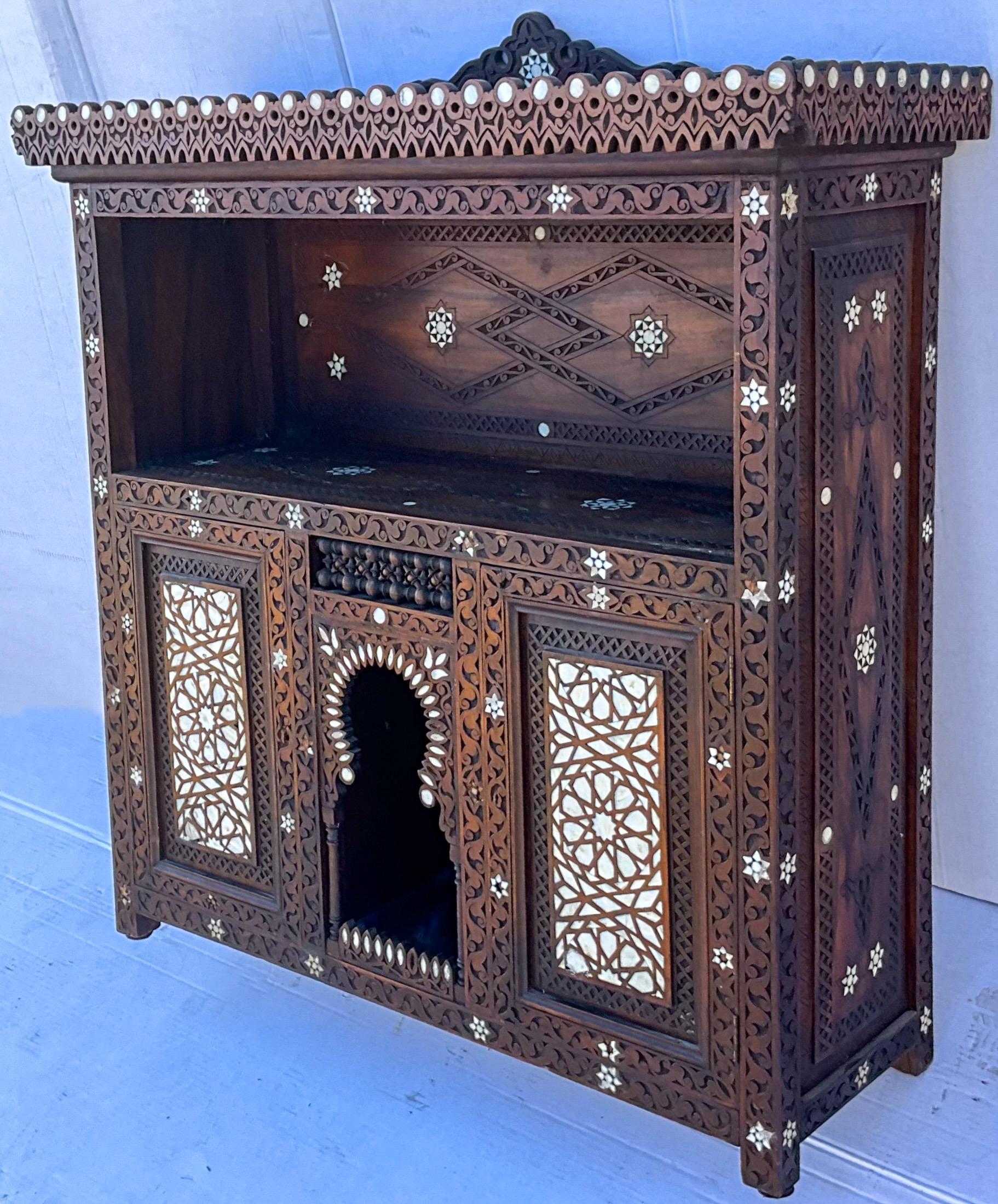 This is an early Anglo-Indian with elaborate mother-of-pearl inlay and carved and pierced details. The wood is most likely teak. I think it could work well from wall to table.