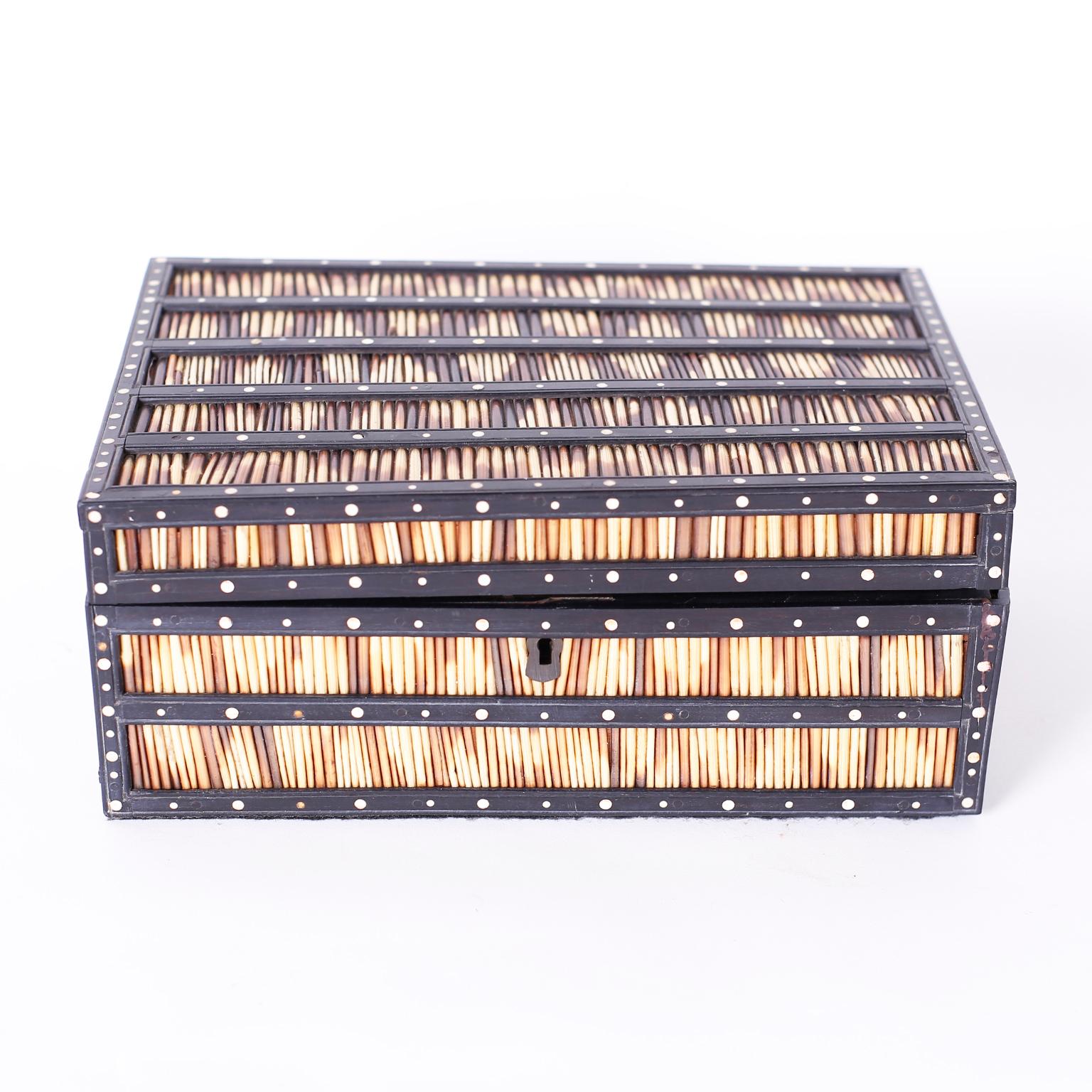 Rare antique Indian porcupine quill lidded box crafted in indigenous hardwood decorated with bone dots and opens to reveal nine lidded compartments in a removable tray.