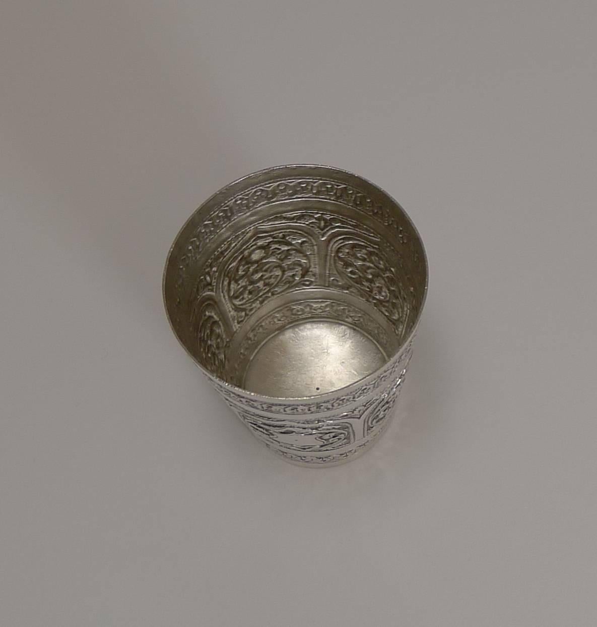 A late 19th century Anglo-Indian sterling silver beaker beautifully decorated with scroll and floral motifs.

Unmarked (but tests as sterling), I would suspect this example to have been made in the Kutch region.

Highly decorative and in