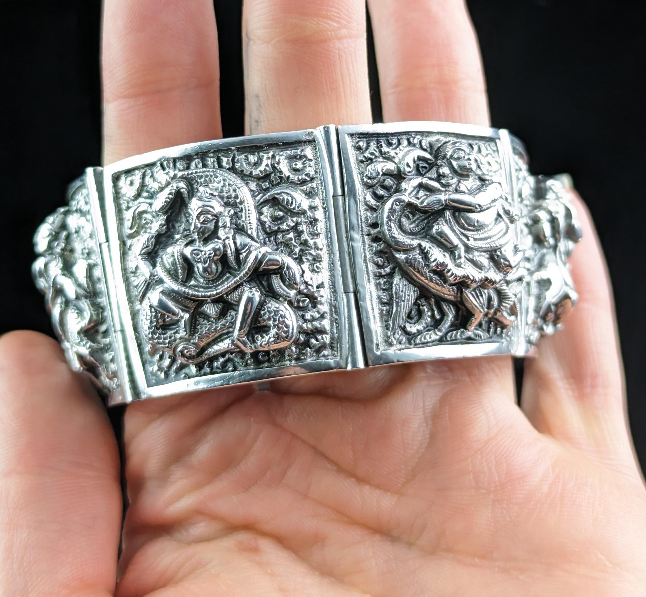 You can't help but be enchanted with this gorgeous, rare antique, Victorian era, sterling silver panel bracelet.

It is very heavy and chunky, made up from individual panels each decorated with the most fantastic high relief designs of Buddhist