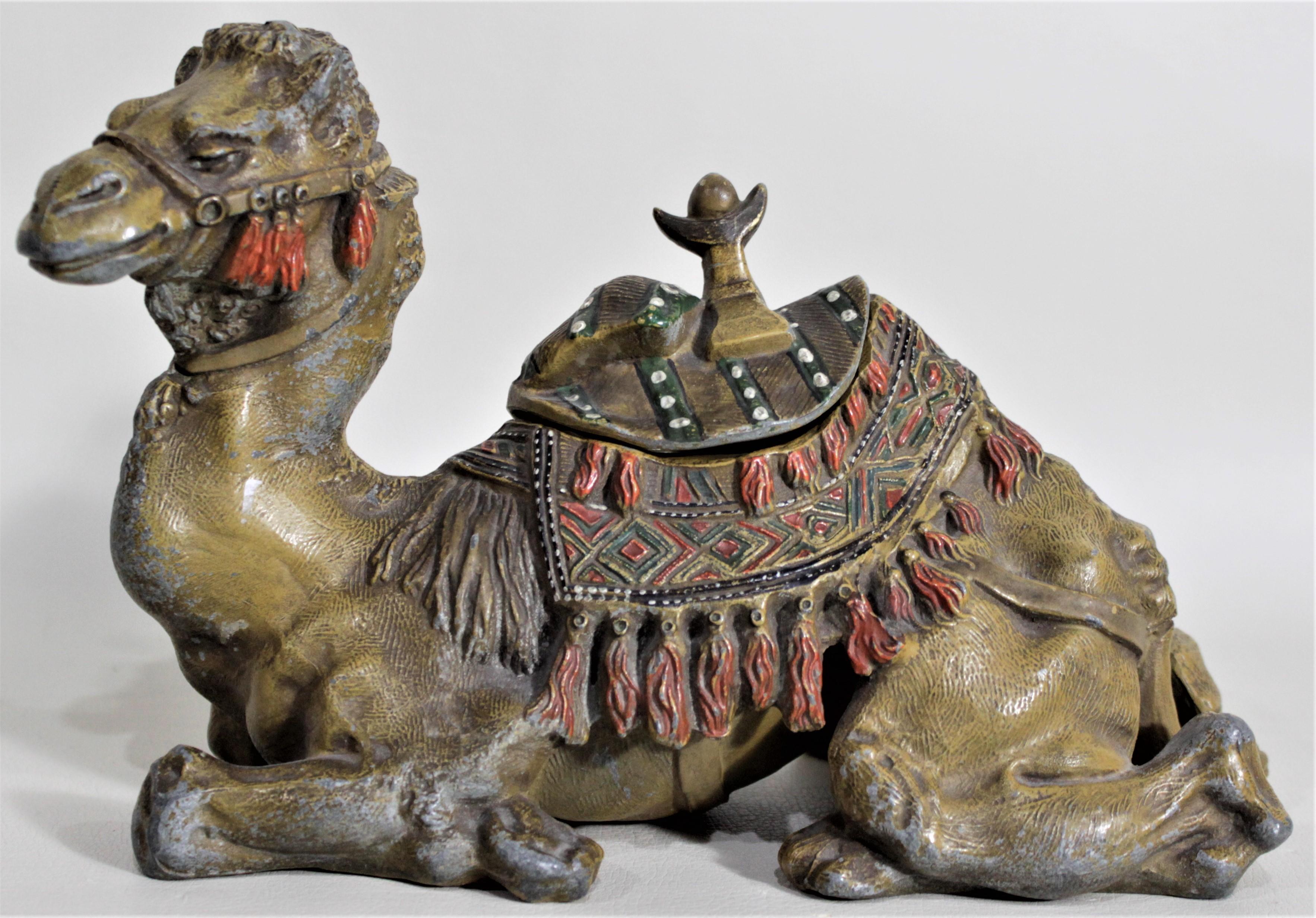 This antique cast and cold-painted inkwell has no maker's marks, but presumed to have been made in Austria in circa 1900 in the Anglo-Indian style. This ornately cast figural sitting camel has been ornately hand-painted in a realistic style and the