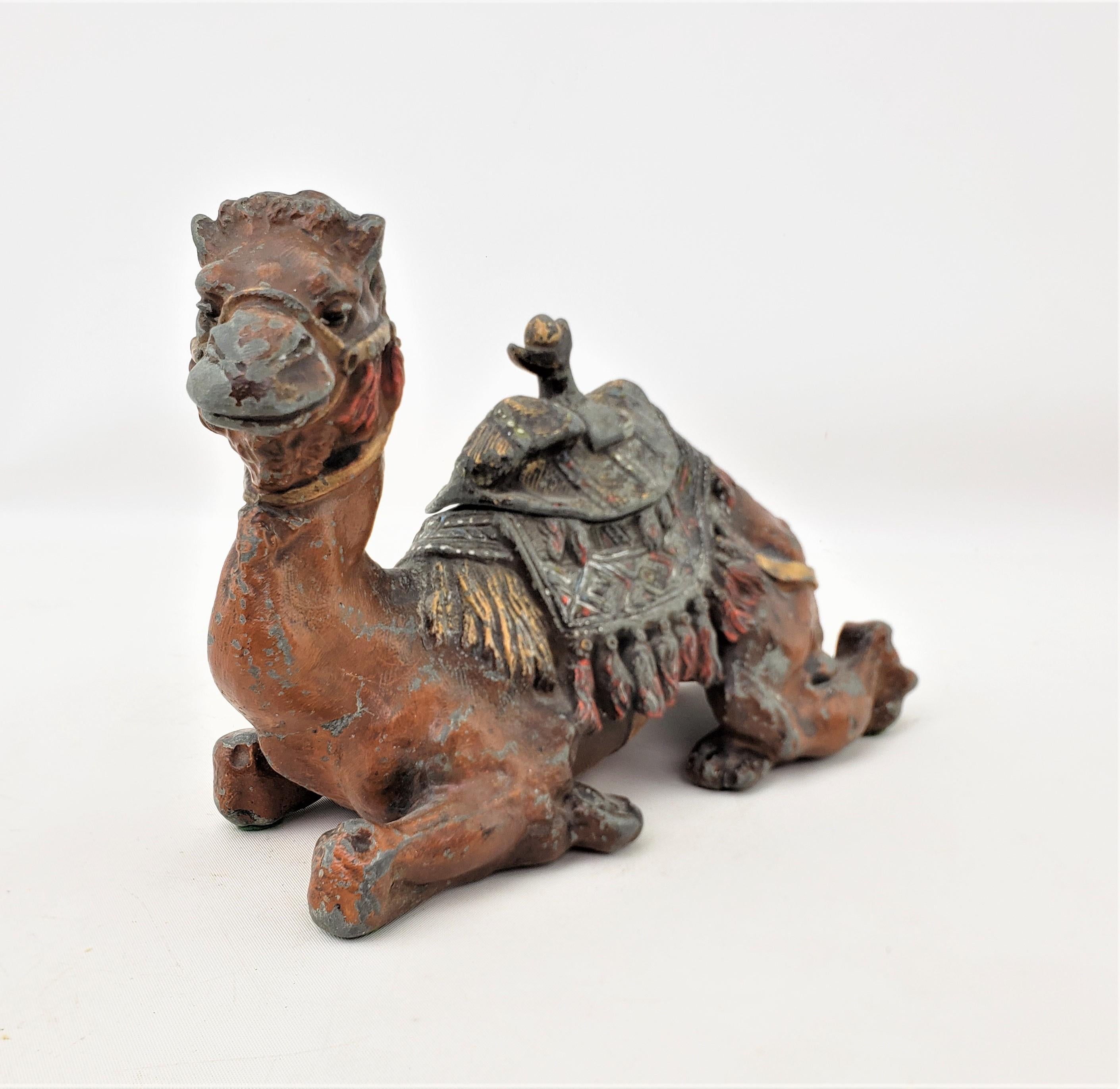 This antique cast and cold-painted inkwell has no maker's marks, but presumed to have originated from Austria and dating to approximately 1900 and done in the Anglo-Indian style. This ornately cast figural sitting camel has been hand-painted in a