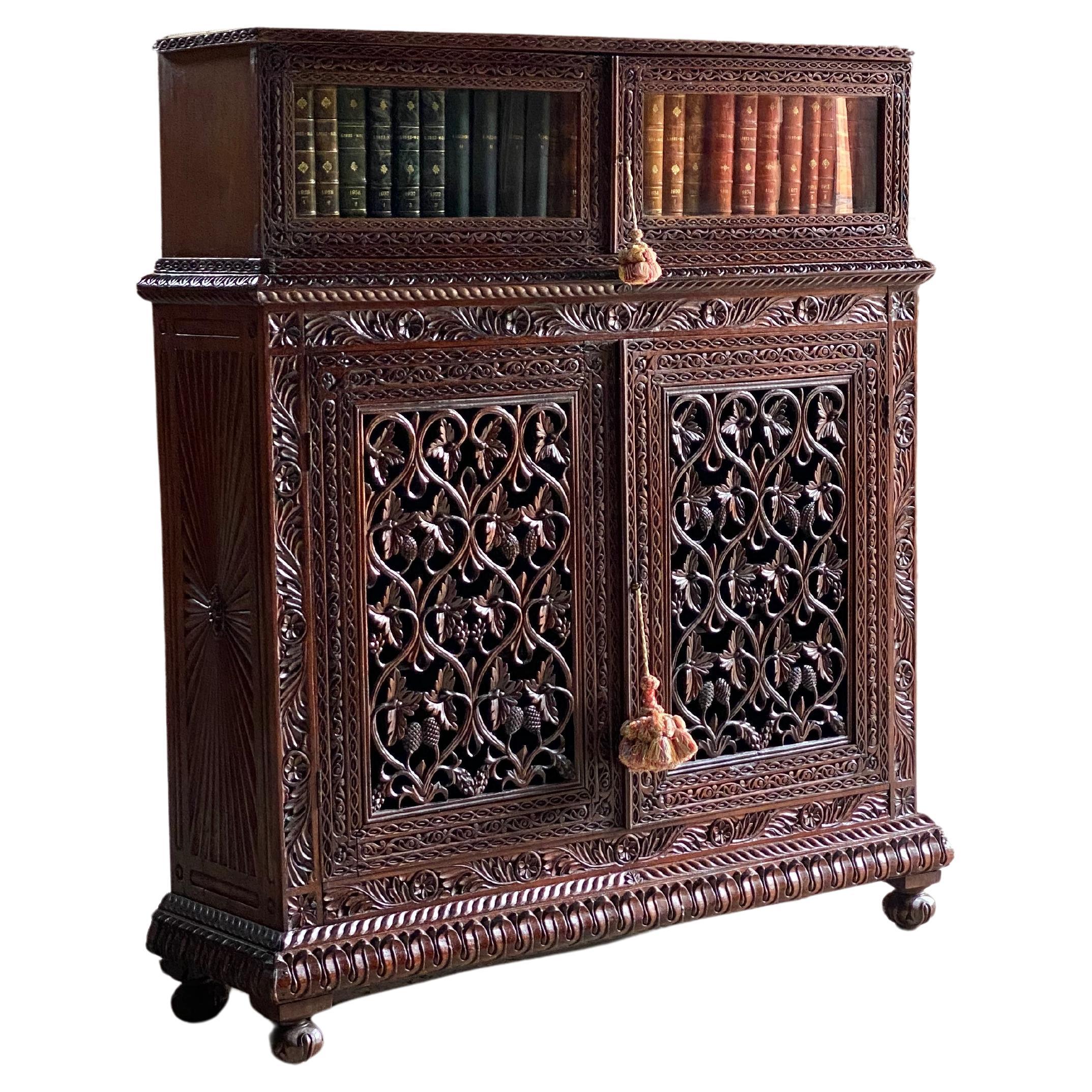 Antique Anglo-Indian Sunburst Teak bookcase cabinet Circa 1850

Stunning mid 19th century Anglo-Indian Teak Sunburst Bookcase Cabinet India circa 1850, made in two parts, all in solid teak, the brass galleried upper bookcase section carved and