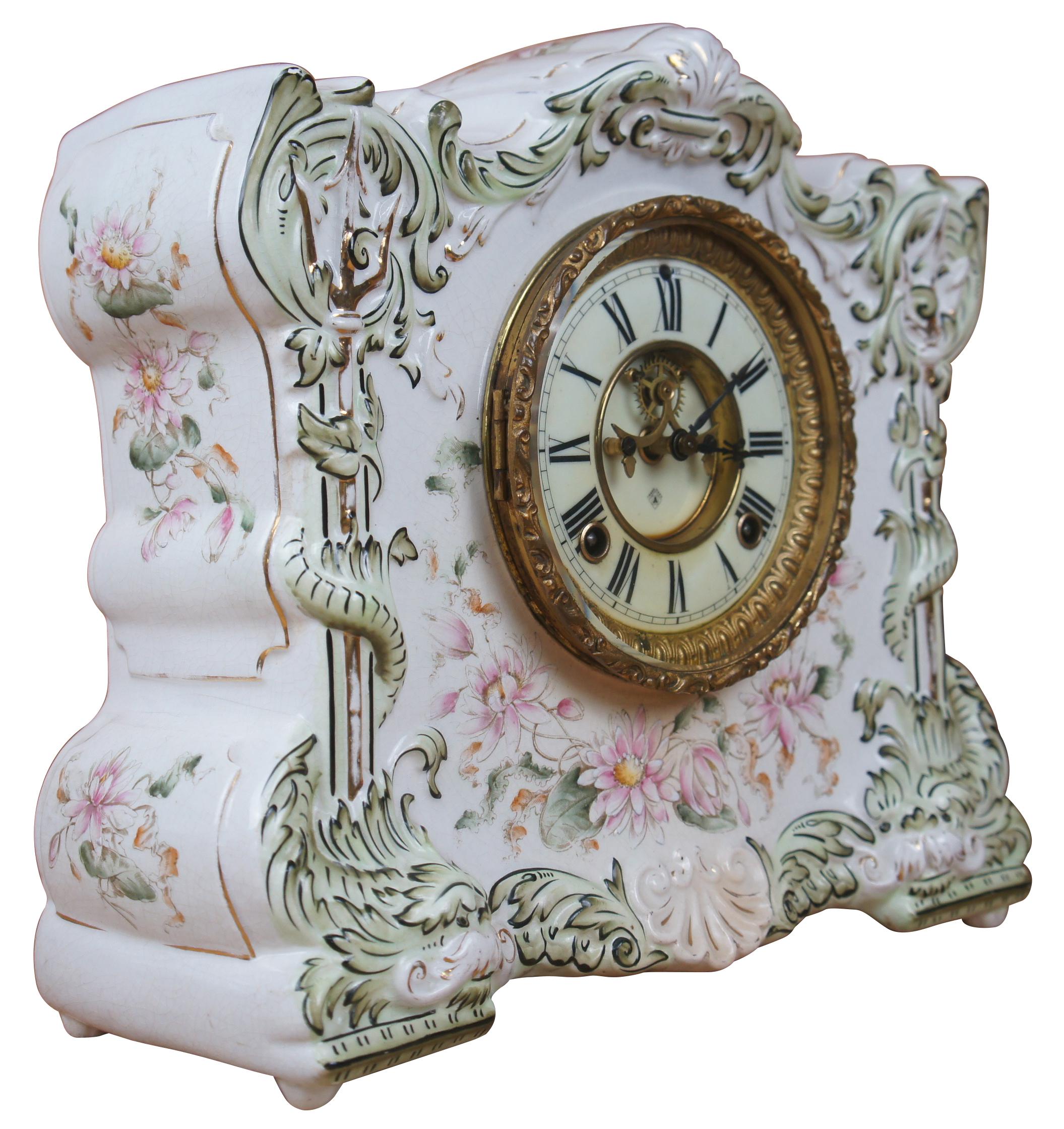 Vintage porcelain mantel clock with hand painted floral and gilt motif and open escapment by Ansonia Osceola Royal Bonn.
   
