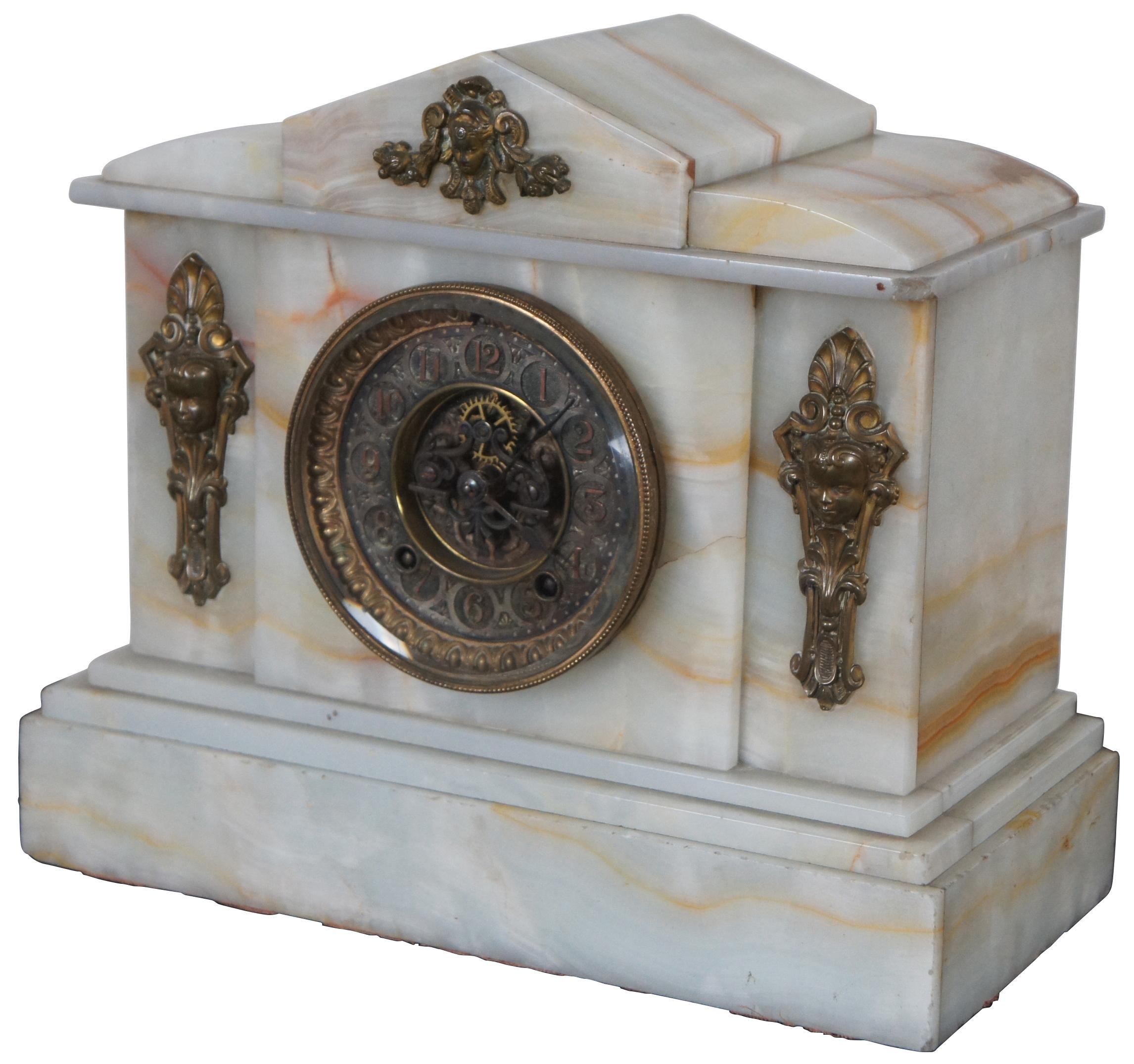 Antique Ansonia white onyx mantel clock with brass face and ormolu caryatid mounts. Features open escapement.
 