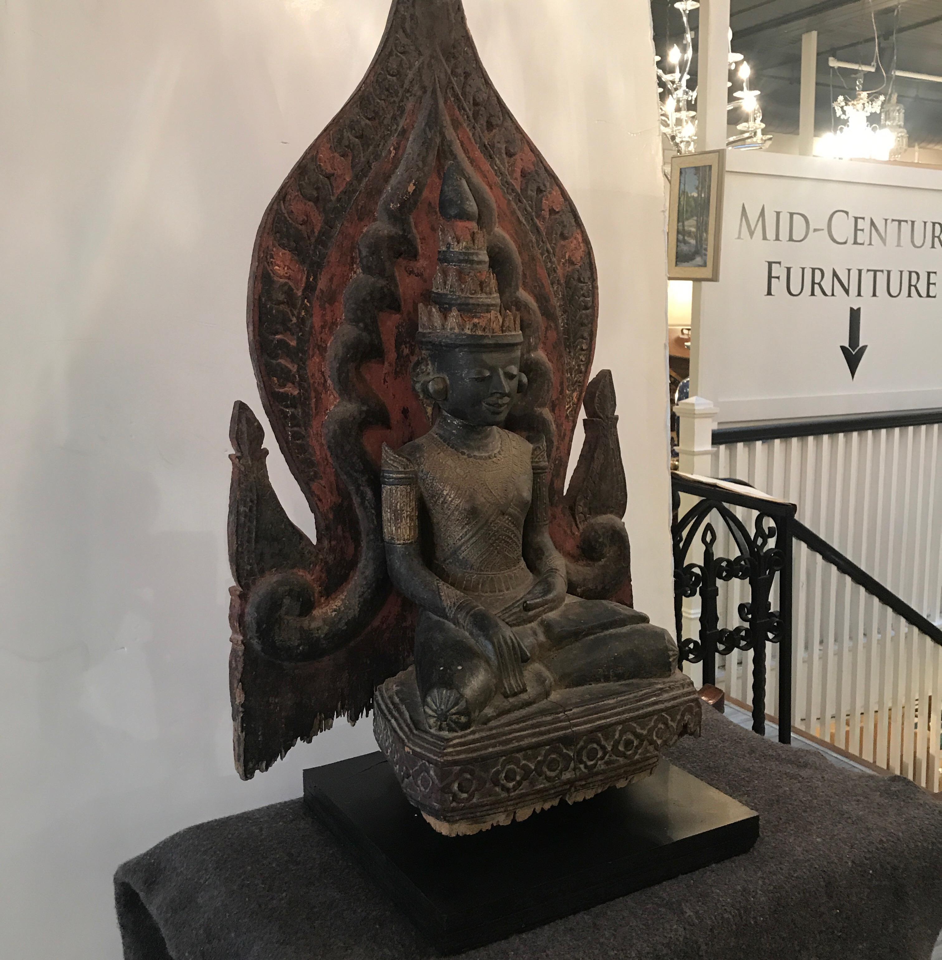 Rare large Thai Buddha sculpture from the mid-19th century. The central figure with shield back retaining some original color and paint. Some expected chipping and wear to original sculpture with a recent black painted wood base.