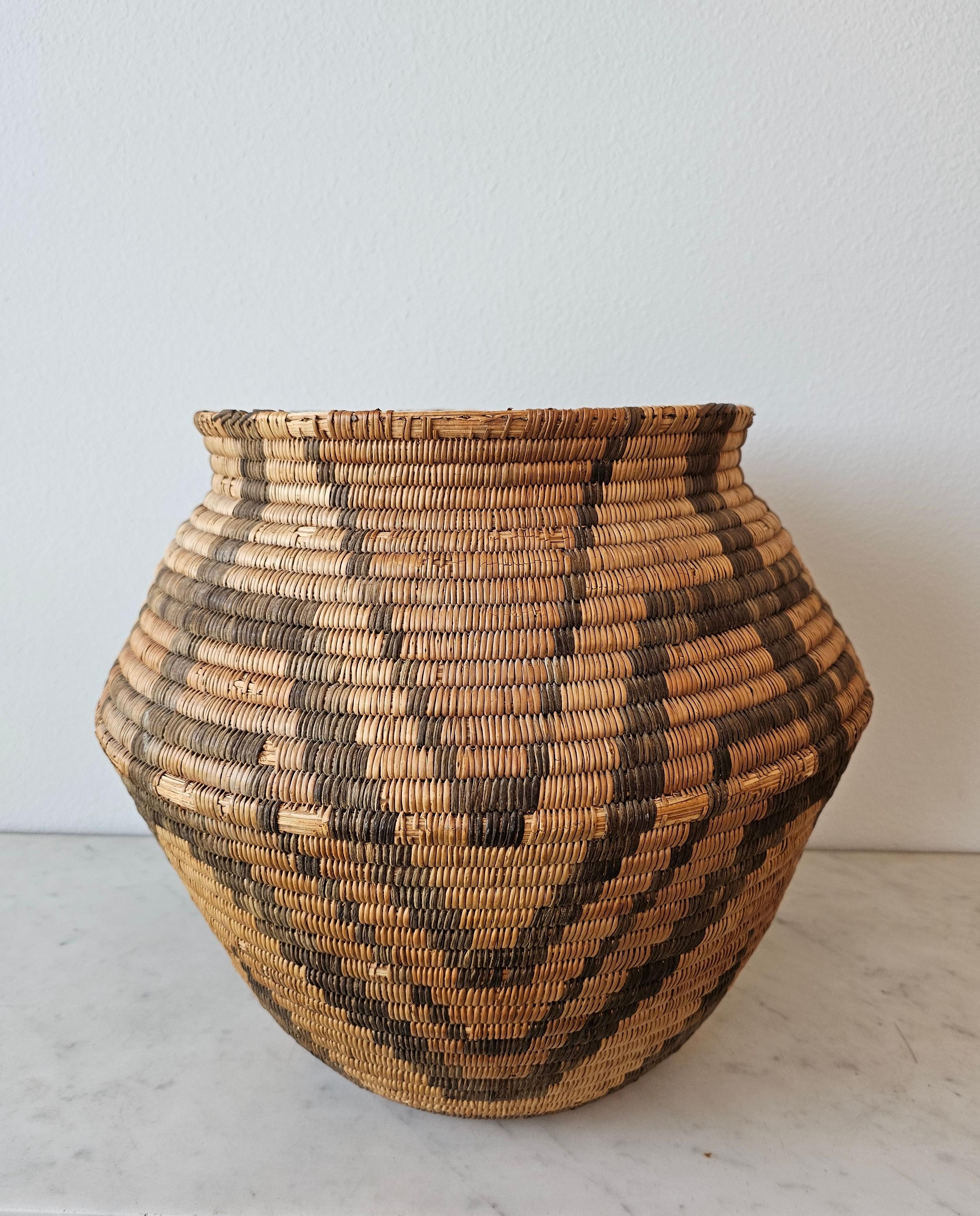 A magnificent Apache Native American coiled olla jar shaped basket, willow, devil's claw. Early 20th century, Southwestern United States, most impressive large size, primitive hand-woven willow and devil's claw natural fiber construction,