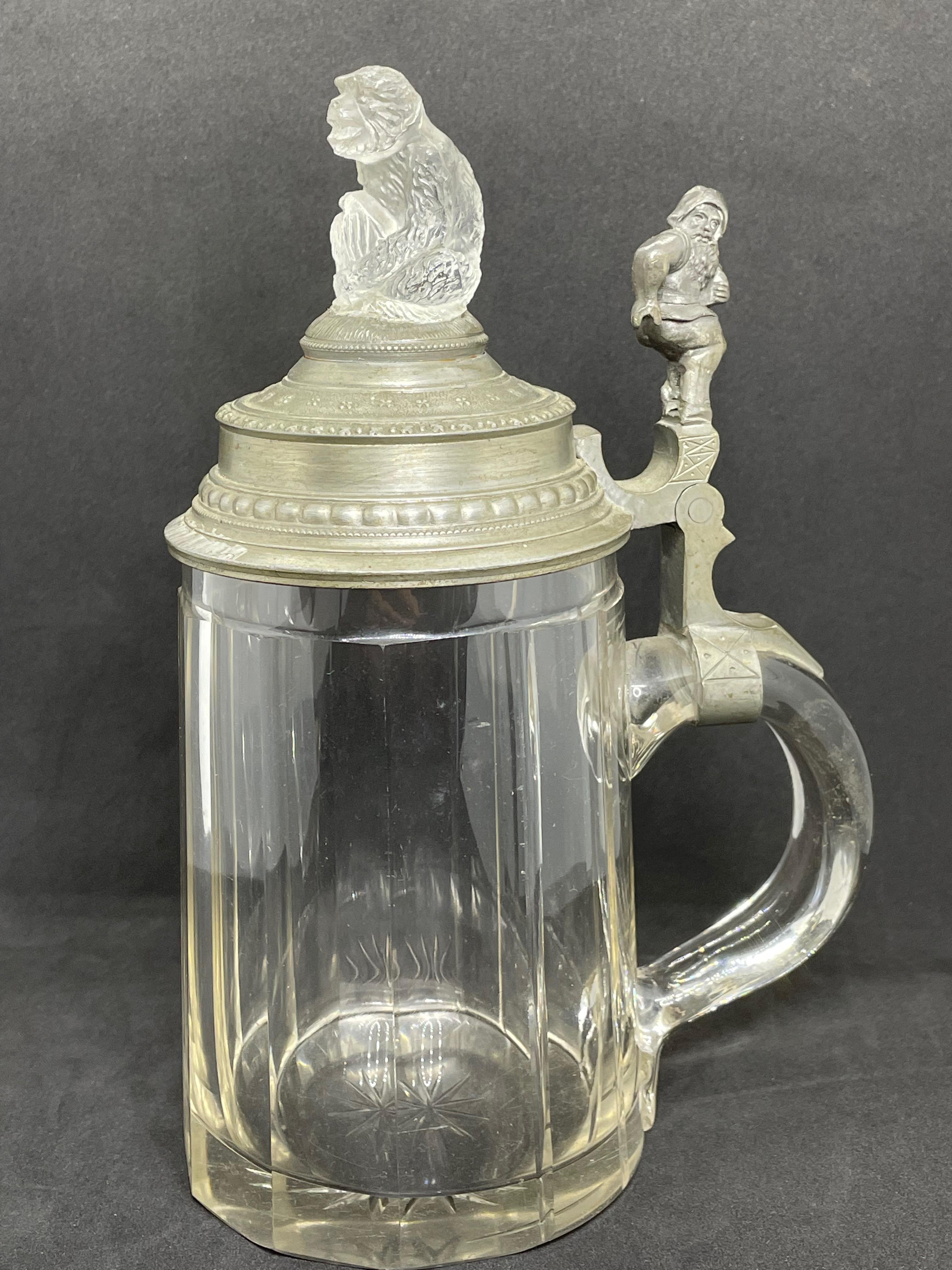 A gorgeous beer stein, made in Germany. This beer stein has been made in Germany, circa 1890s. Absolutely gorgeous piece still in great condition, without damage. Lid works properly. It is a 1/2 Liter Stein. Has a glass Ape figure on top and a gnome