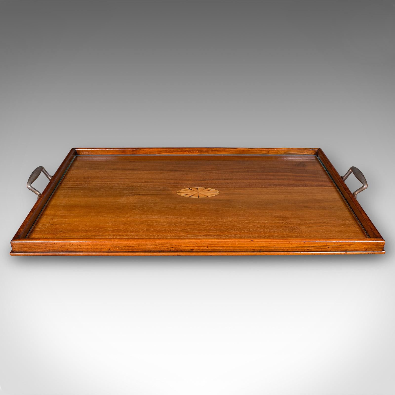 This is an antique aperitif serving tray. An English, walnut afternoon tea platter with glass top, dating to the Edwardian period, circa 1910. A fine example of Edwardian craftsmanship, offering both decorative appeal and practical serving