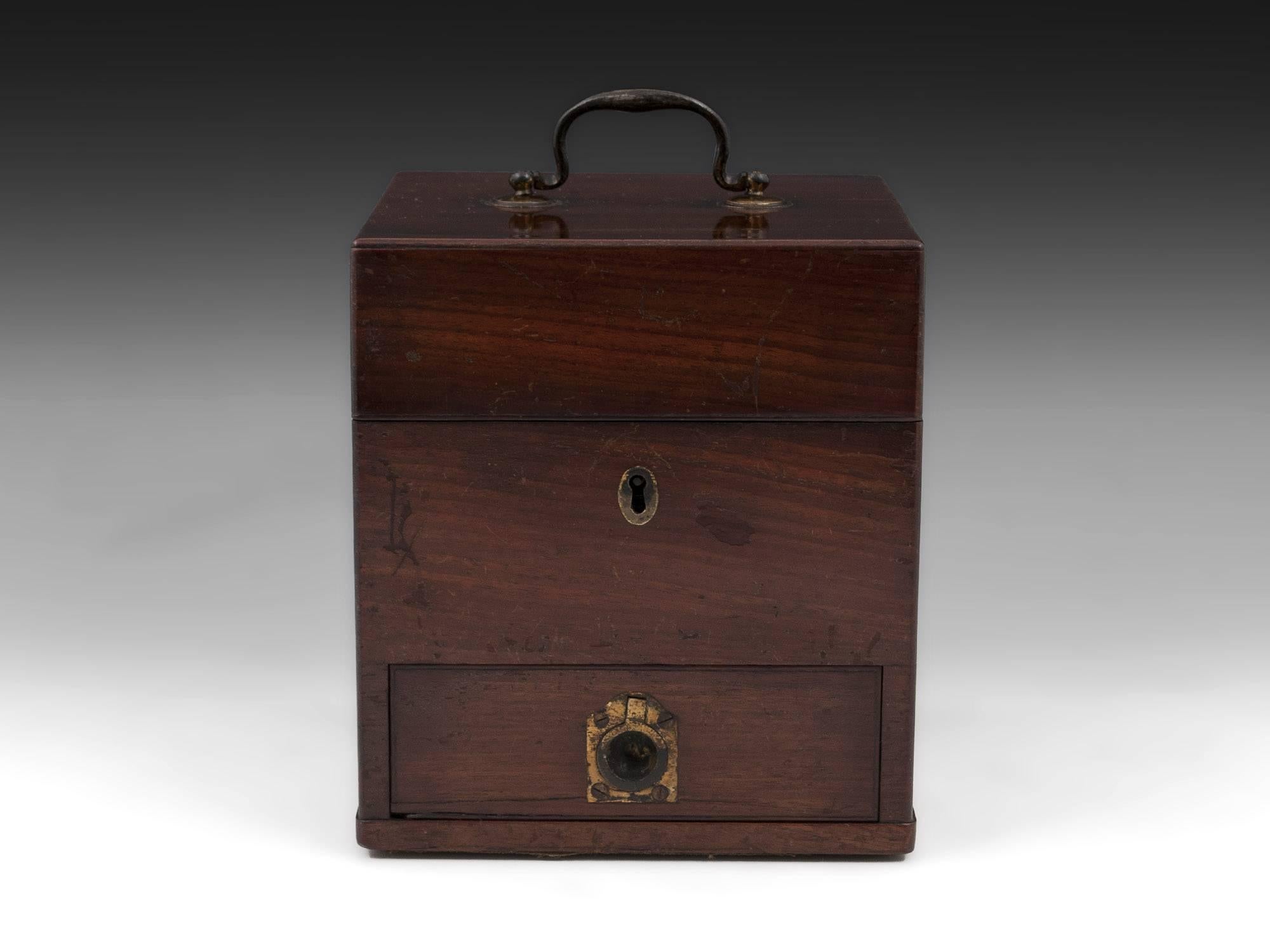 Antique apothecary box with large brass carry handle, escutcheon and drawer pull. 

Open the box reveals eleven various labelled and unlabelled bottles, some still containing their original contents. Each housed in a wooden compartment. The