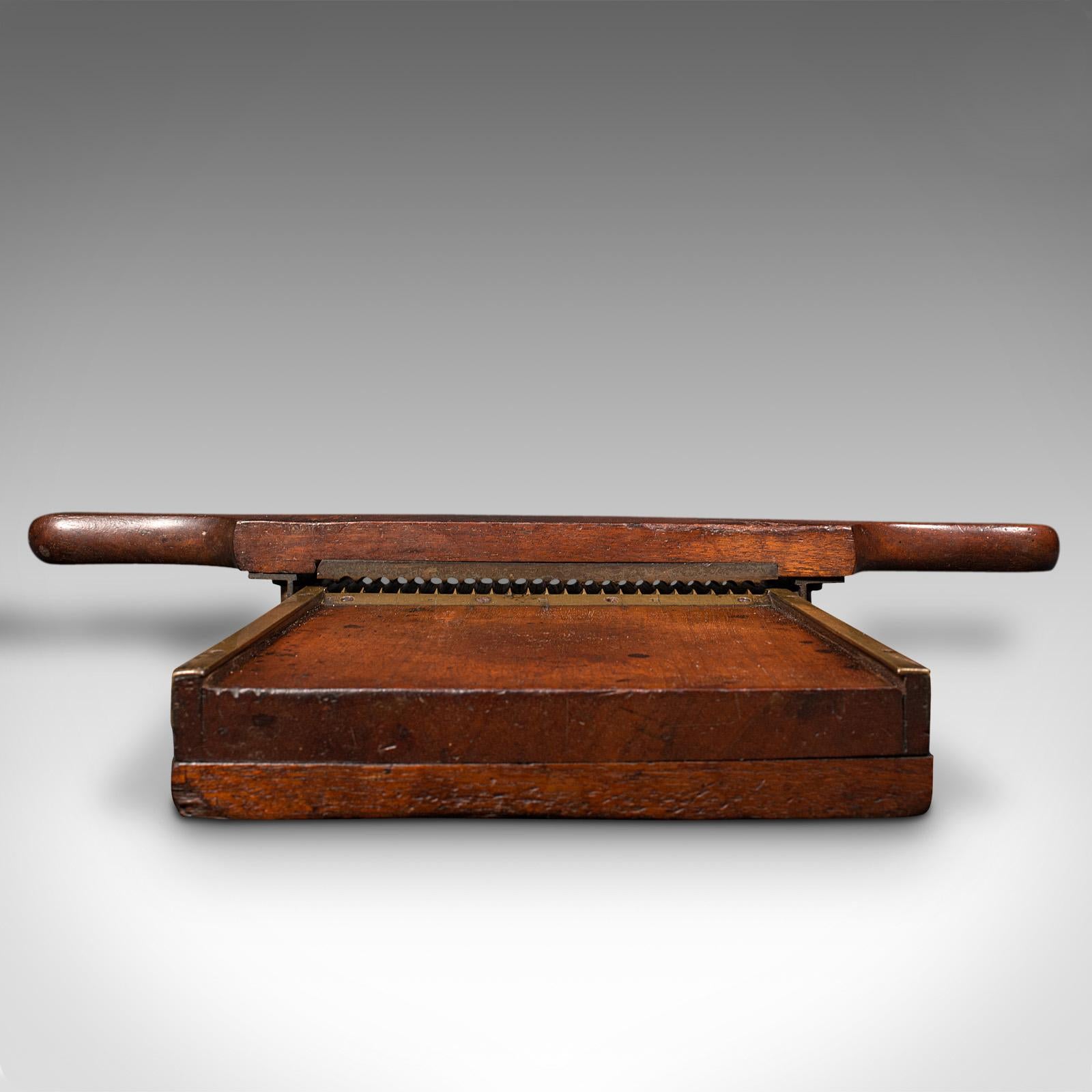 This is an antique apothecary pill rolling machine. An English, mahogany and brass chemist's countertop instrument, dating to the early Victorian period, circa 1850.

Fascinating example of an apothecary roller, with a desirable display