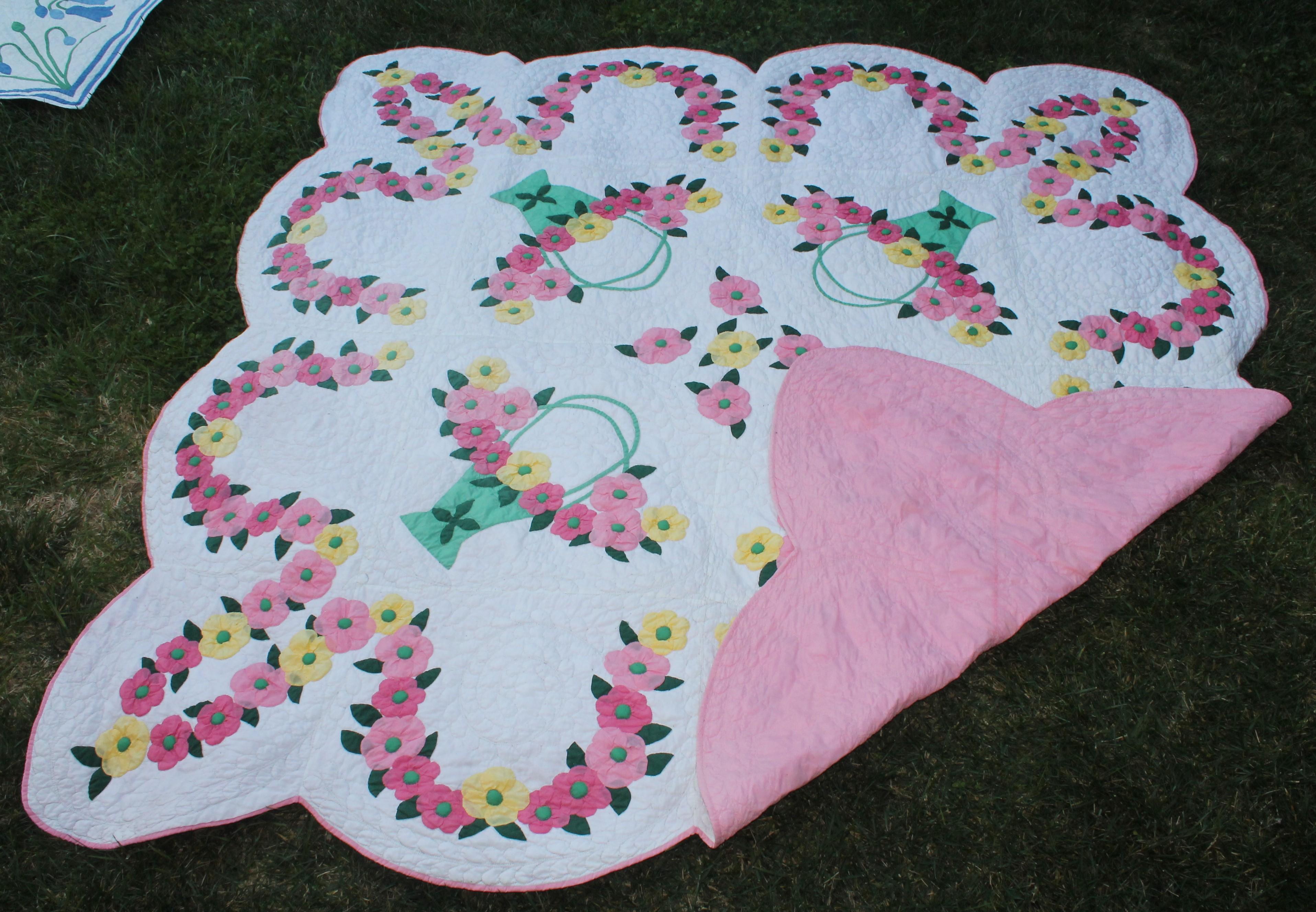 Antique applique quilt with dogwood flowers and baskets. The detail work is amazing. Tight stitching and fine applique. Looks like a Marie Webster quilt.