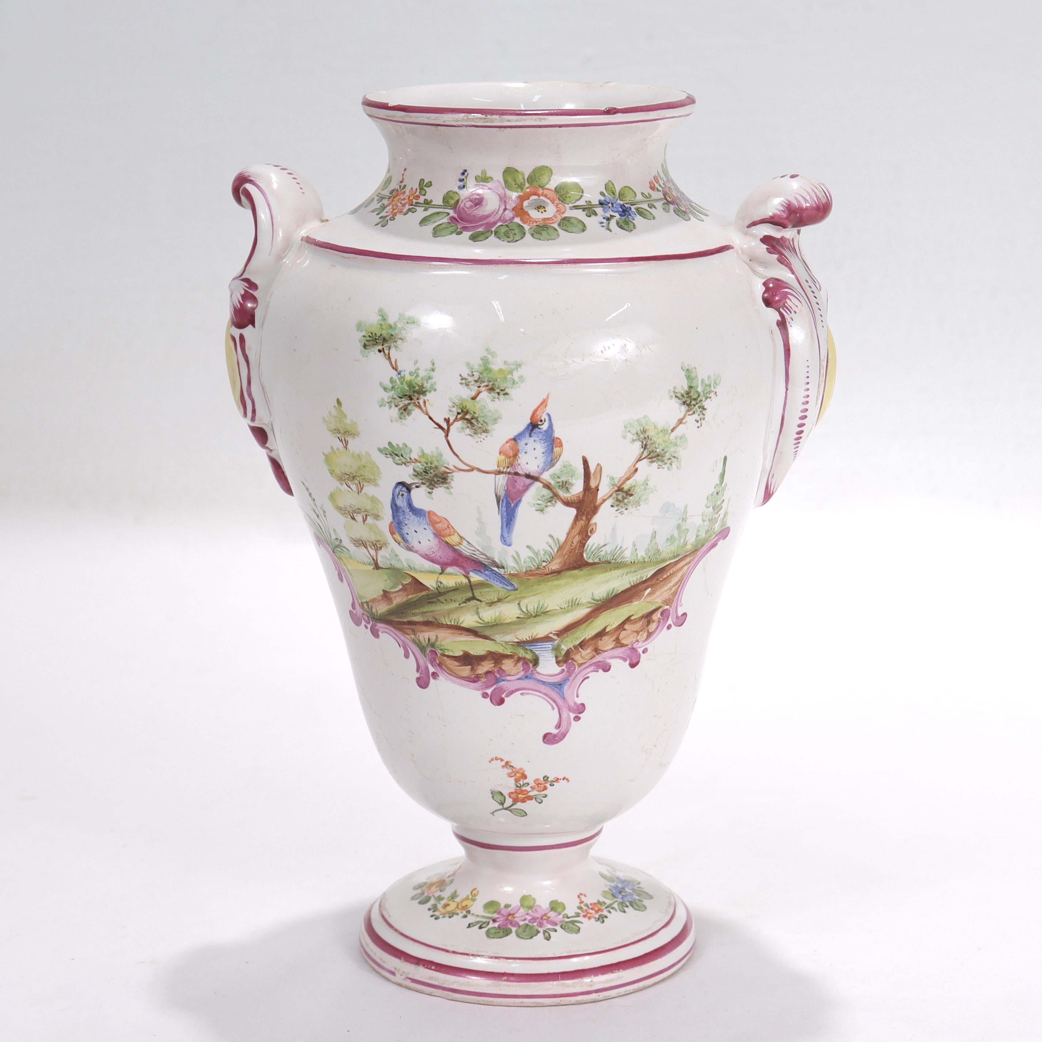A fine antique French faience vase.

By Aprey.

Decorated throughout with floral devices and purple accents with a nature scene of two birds to one side.

With two rocaille handles.

Simply a great vase from Aprey!

Date:
Late 18th or