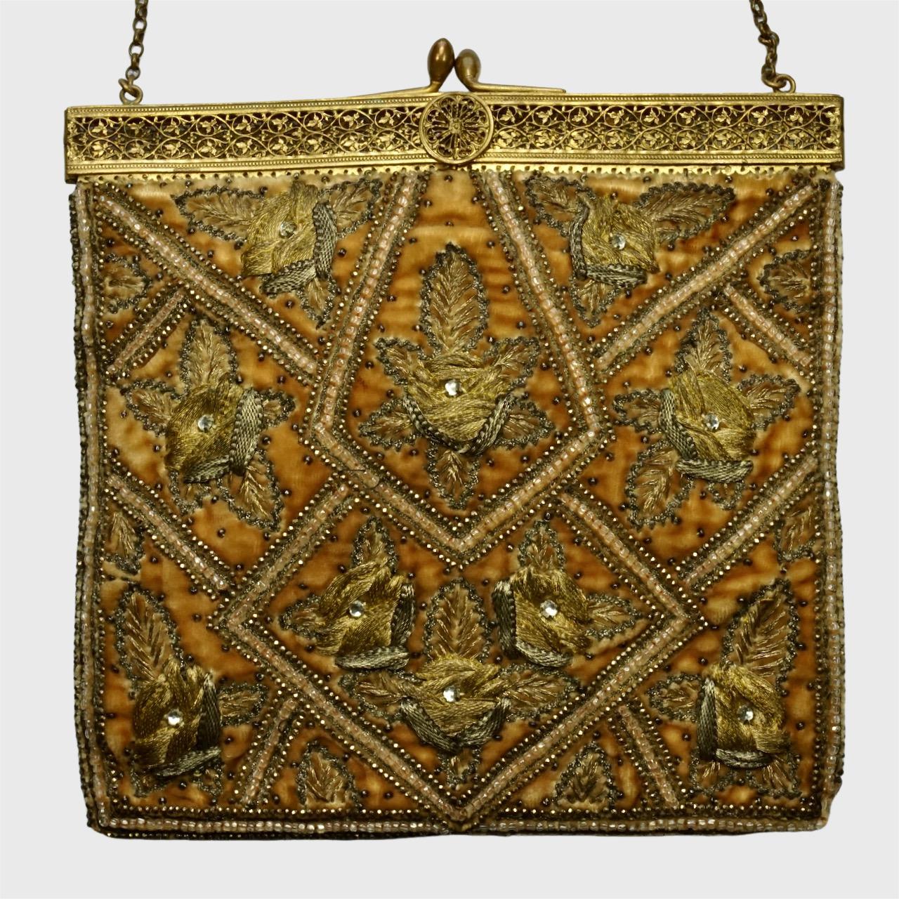 Fabulous antique dark apricot velvet bag in a floral design, with couch work gold and silver metallic embroidery on both the front and back, and a lovely floral filigree frame. The beautiful embroidery work is intricate with threads and beading, and