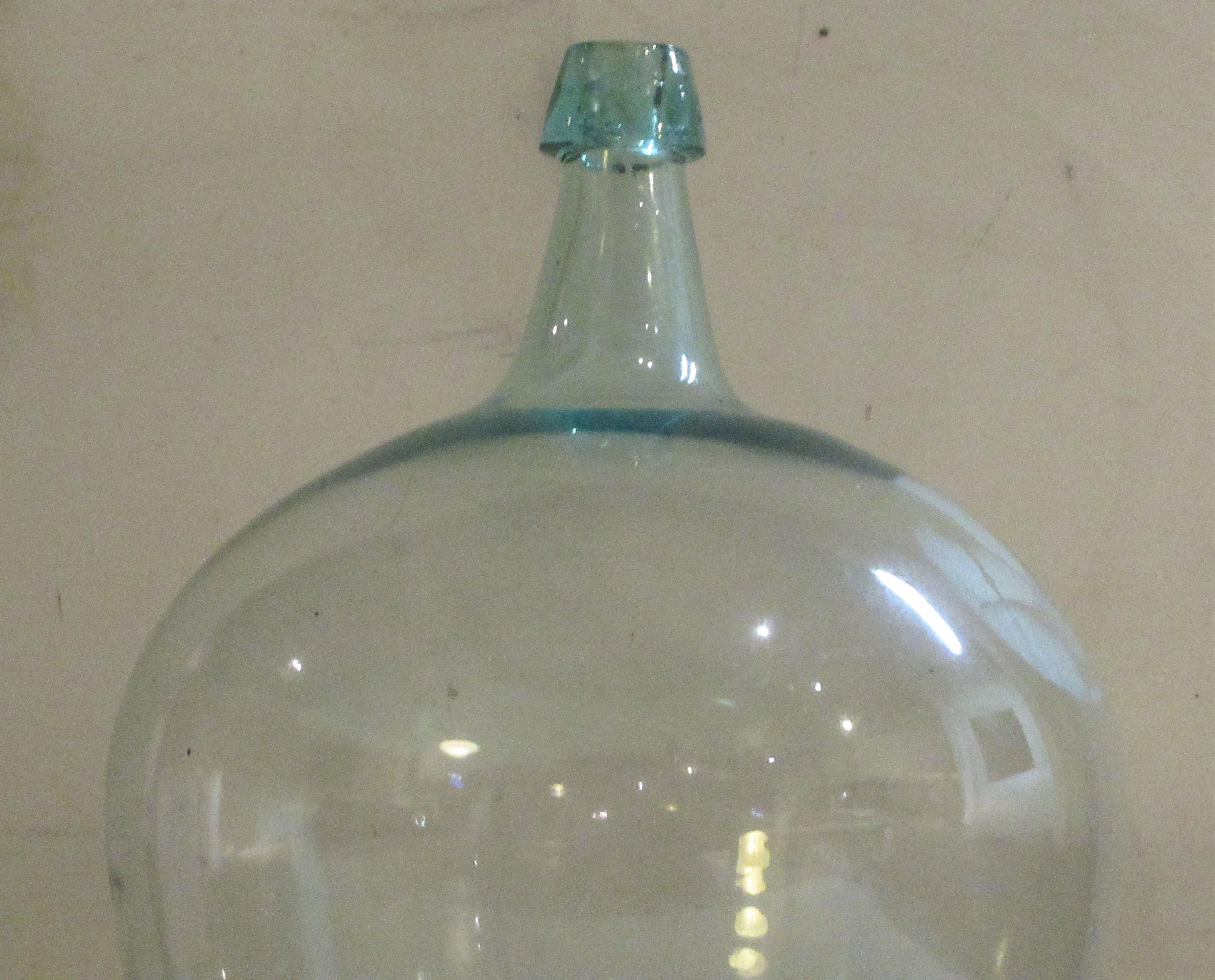 Antique 19th century pale aqua blown glass demijohn bottle with a beautiful bulbous form and deep dished pontil.