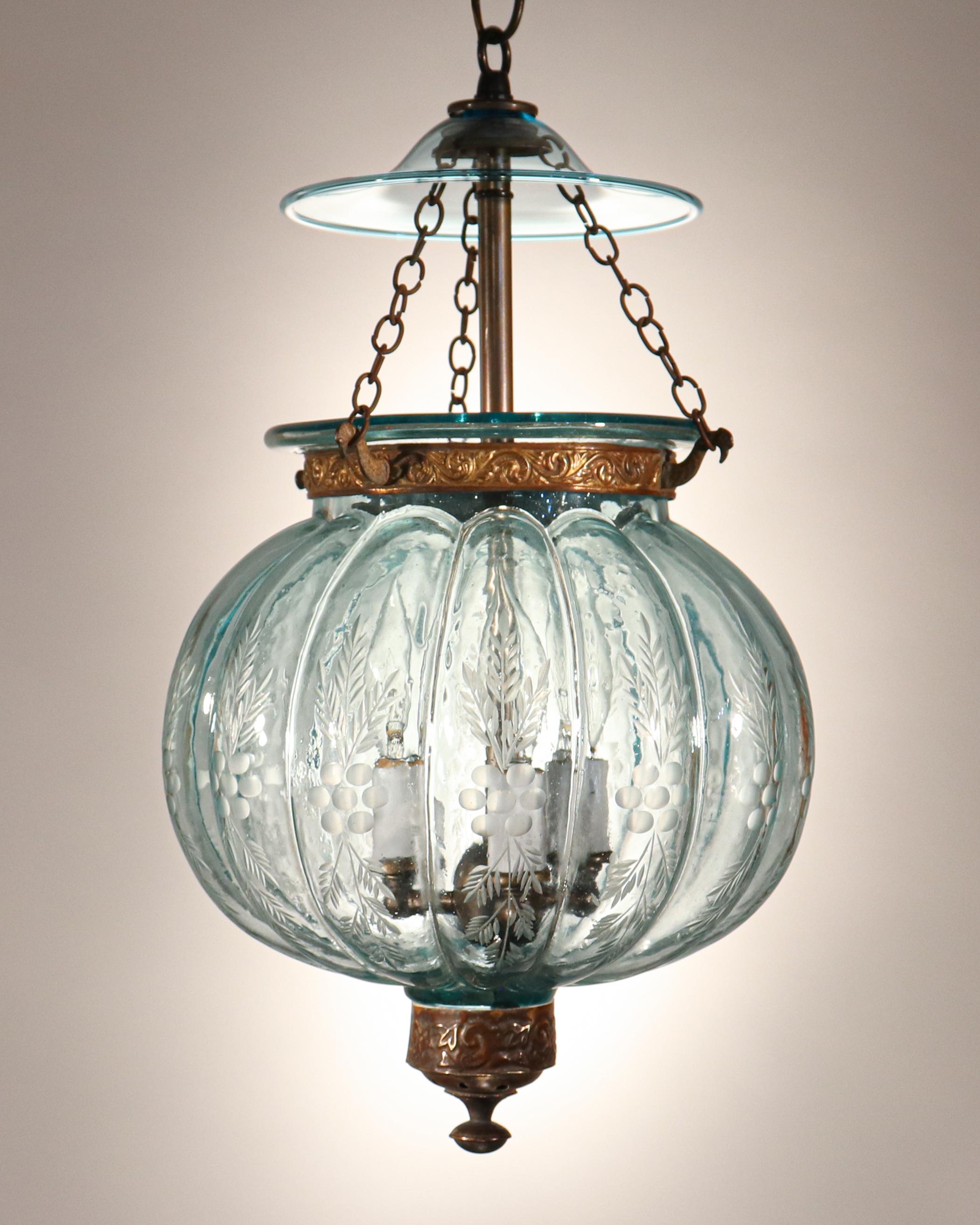 A rare antique Belgian melon bell jar lantern with a beautiful aqua-blue tint. The lantern features excellent quality hand blown glass and a finely etched wheat motif. The brass band and finial are original to the lantern; however, the hand blown