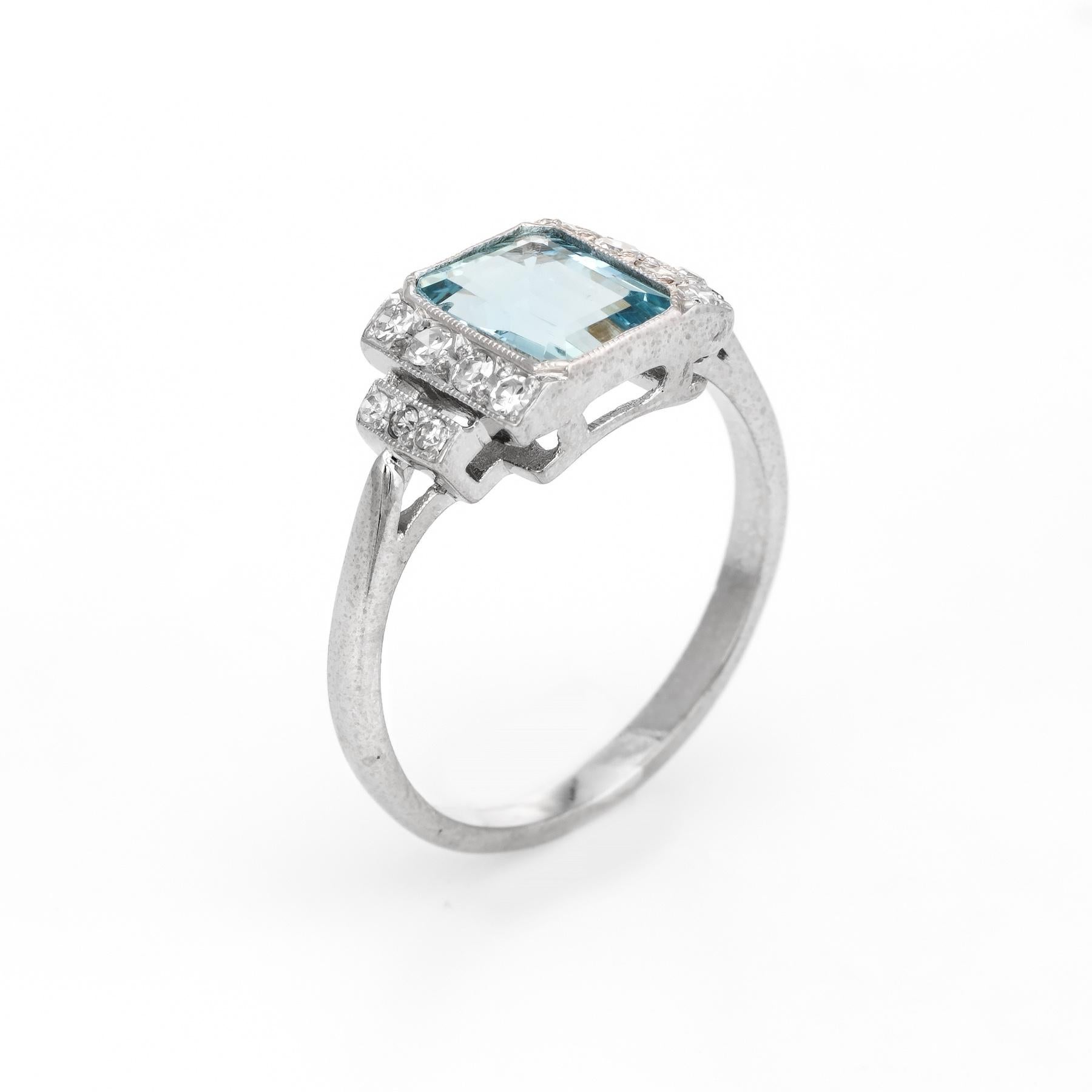 Elegant & finely detailed Art Deco era ring (circa 1920s to 1930s), crafted in 18 karat white gold. 

Centrally mounted aquamarine measures 8mm x 6mm (estimated at 1.50 carats), accented with 14 single cut diamonds totaling an estimated 0.22 carats