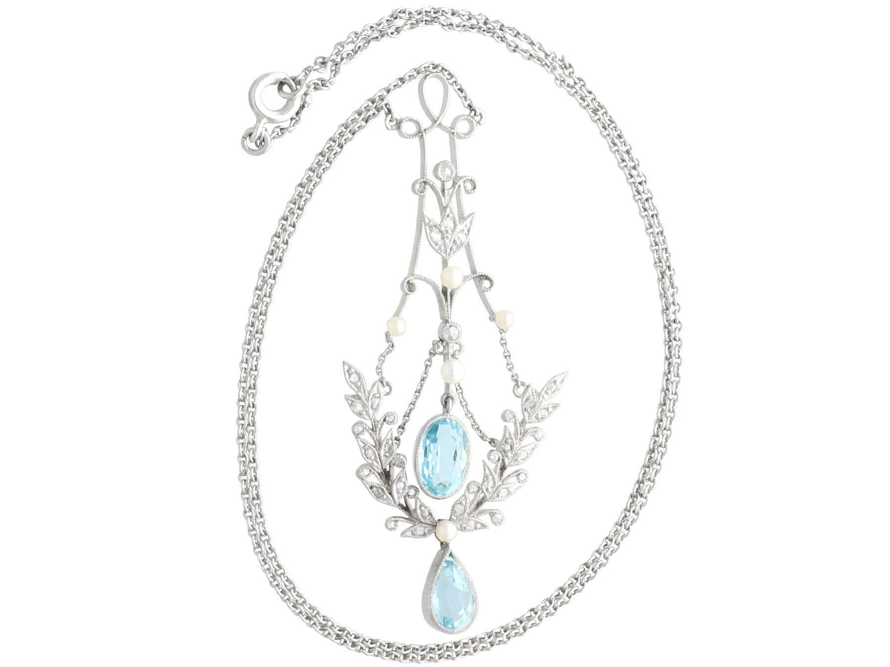 A fine and impressive 1.59 carat aquamarine,1.59 carat diamond and seed pearl, 14 karat yellow gold and platinum pendant; part of our diverse antique jewelry collections

This fine and impressive aquamarine pendant has been crafted in 14k yellow