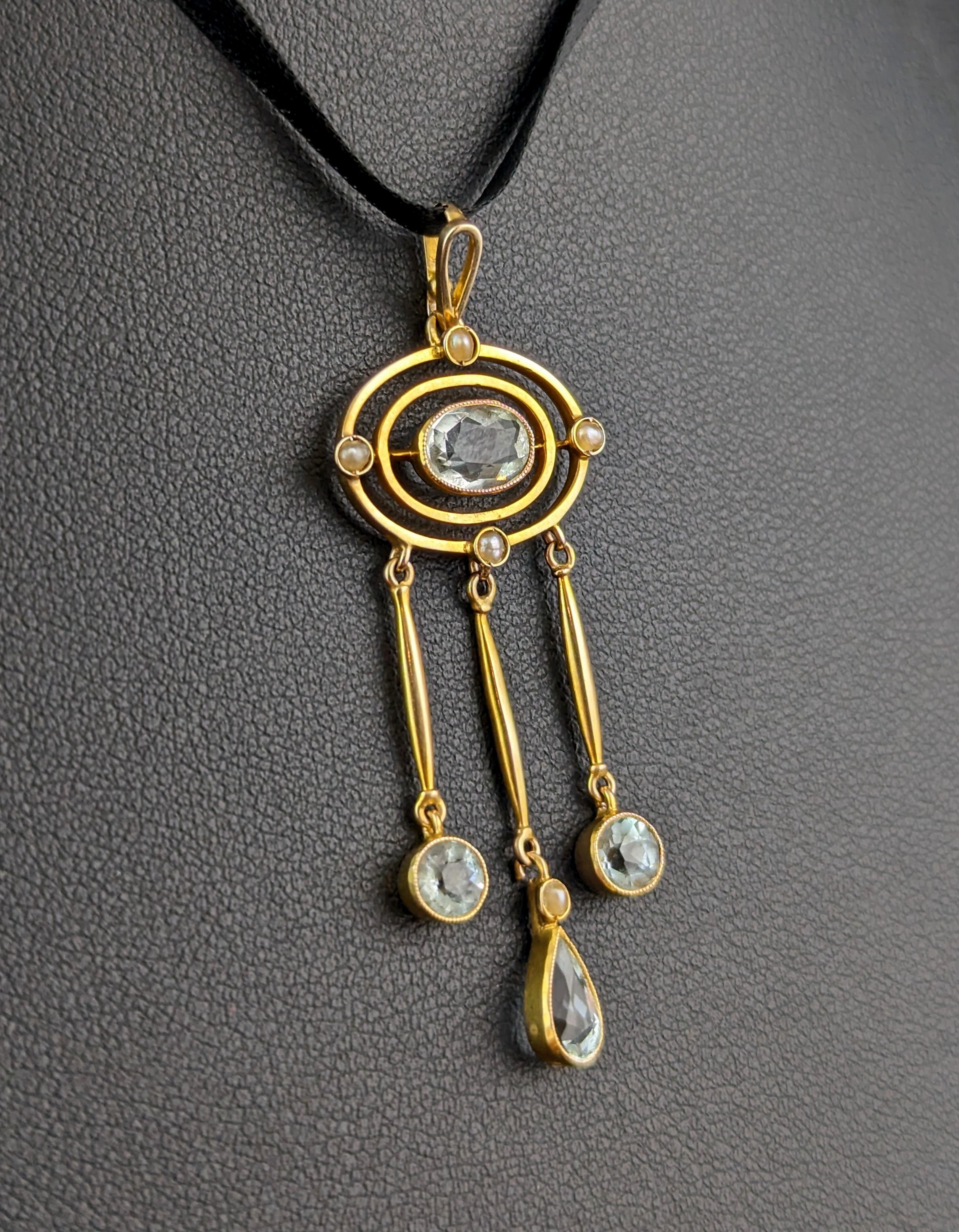 A truly stunning antique Aquamarine drop pendant.

Art Nouveau era this beautiful triple drop pendant emphasises clean lines and geometric shapes combined with delicate yet rich hues and different cut gemstones.

The pendant has an integral pearl