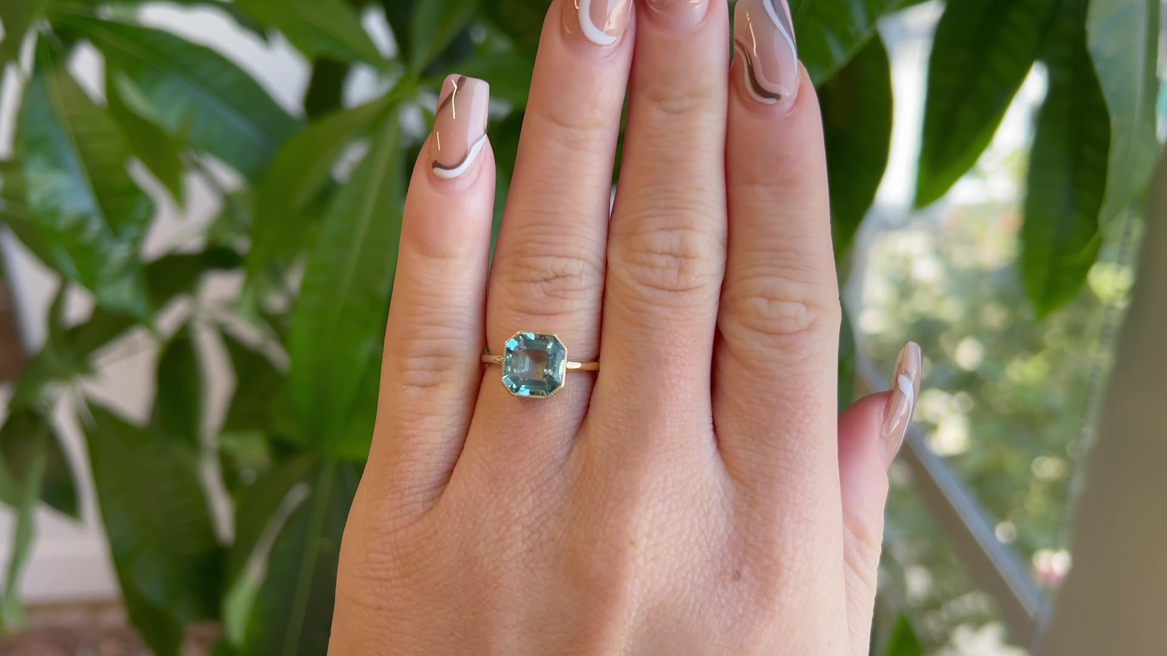 One Antique Aquamarine Gold Solitaire Ring. Featuring one square step cut aquamarine of approximately 2.70 carats. Crafted in yellow gold, converted to a ring from an antique pin, with a modern shank. Circa 1910s. The ring is a size 6 and may be