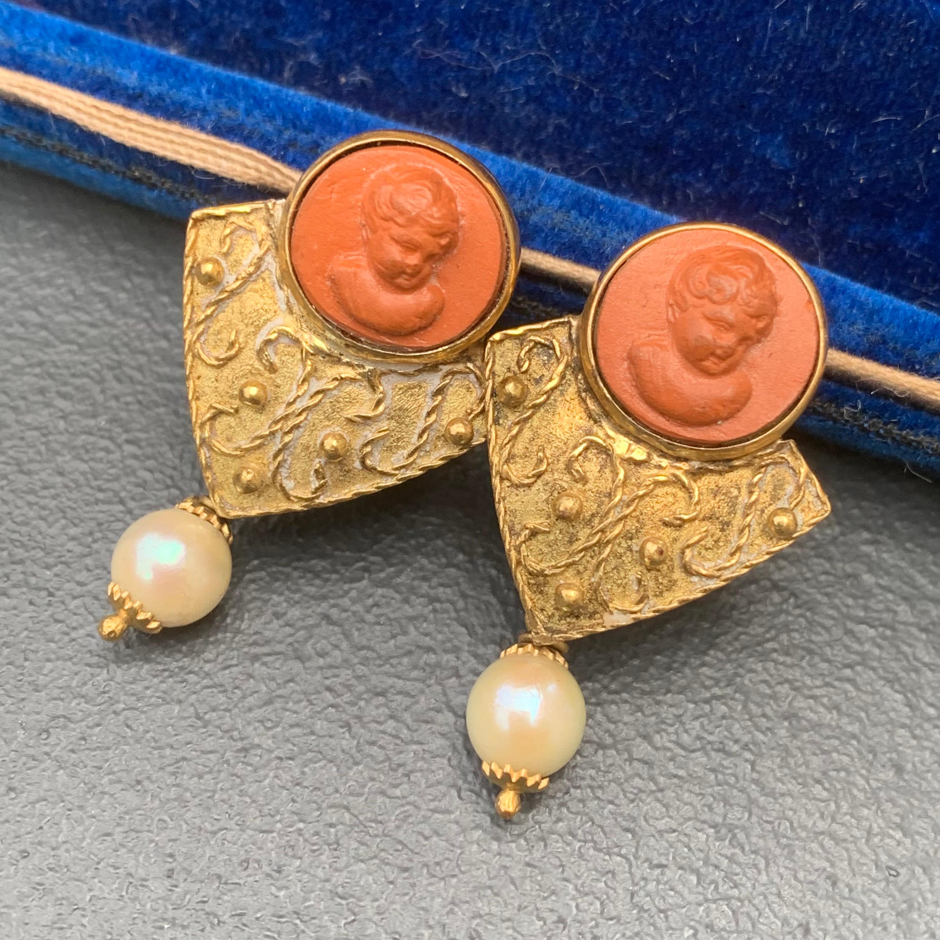 Stunning Antique Victorian era solid 18kt yellow gold earrings for pierced ears featuring carved lava cameo tops . Earrings have Etruscan style applied wire and bead work on front side with cultured pearl dangle .
marked 18kt ITALY with faded stamp