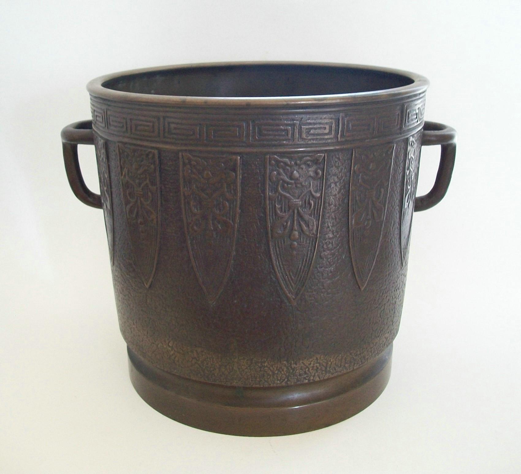 Archaic style antique bronze planter - large size - featuring fine casting with over-all textured finish, decorative elements and Greek key border to the rim - applied tripod handles - recessed base - original brown patina remains over-all - signed
