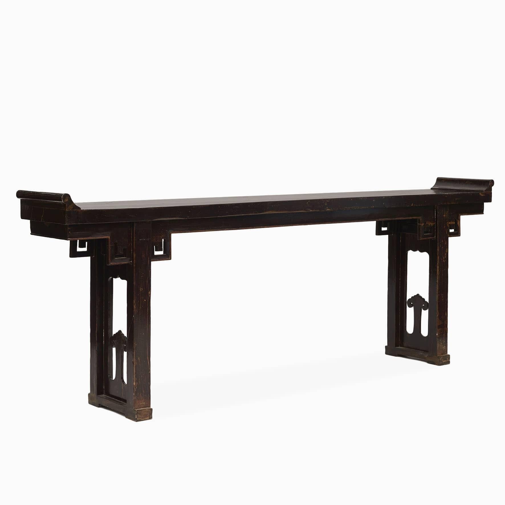 A long and elegant altar or console table in original condition. 
Walnut with a dark burgundy lacquer. Carved details and spandrels on both side of the table. Freestanding.
Good craftsmanship with natural age-related patina.
Chinese altar tables