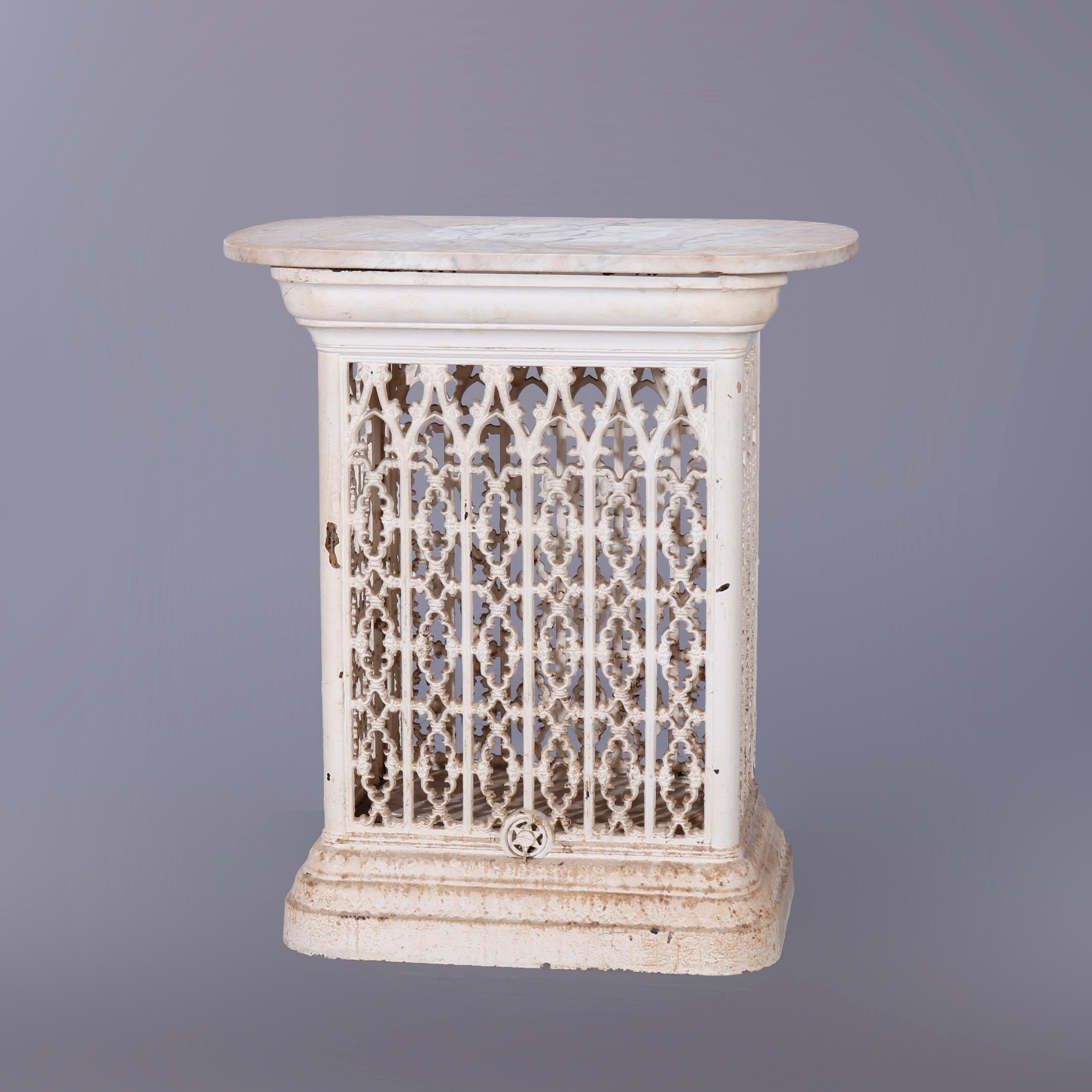 An antique architectural garden table offers marble top surmounting painted cast iron reticulated basket base, repurposed architectural element, circa 1890

Measures - 30.75''H x 27''W x 17.75''D.
