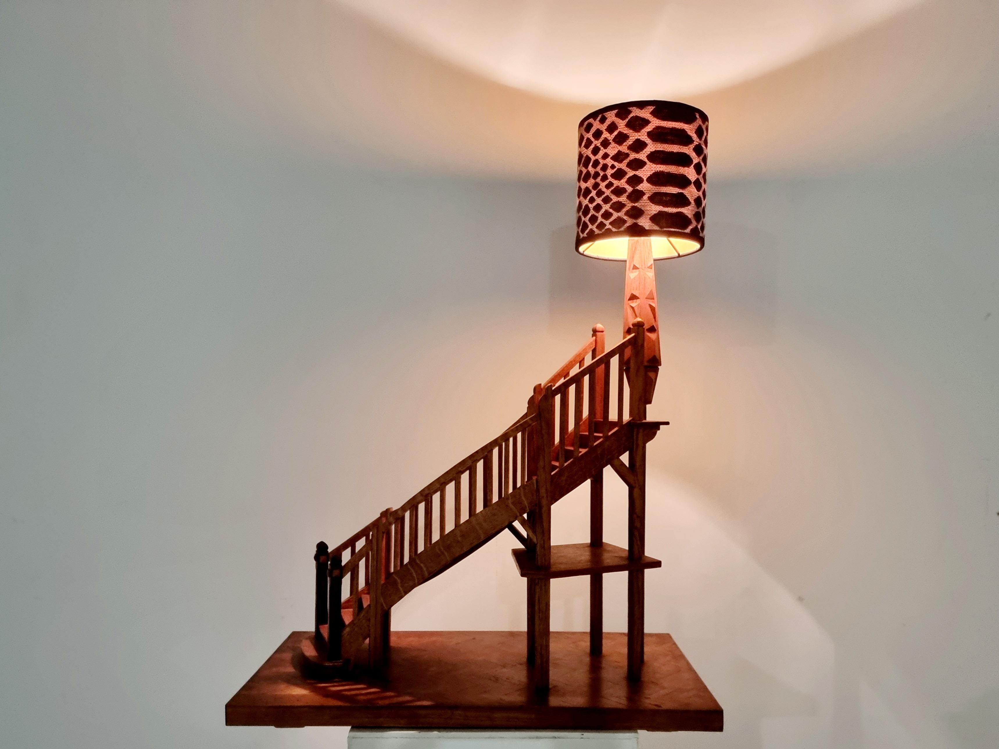 An antique walnut staircase decor from France, circa 1930. With a Classic design with numerous steps supported on a square base, in a herringbone pattern, This specific staircase is made to use as a lamp. A unique and collectible piece. The
