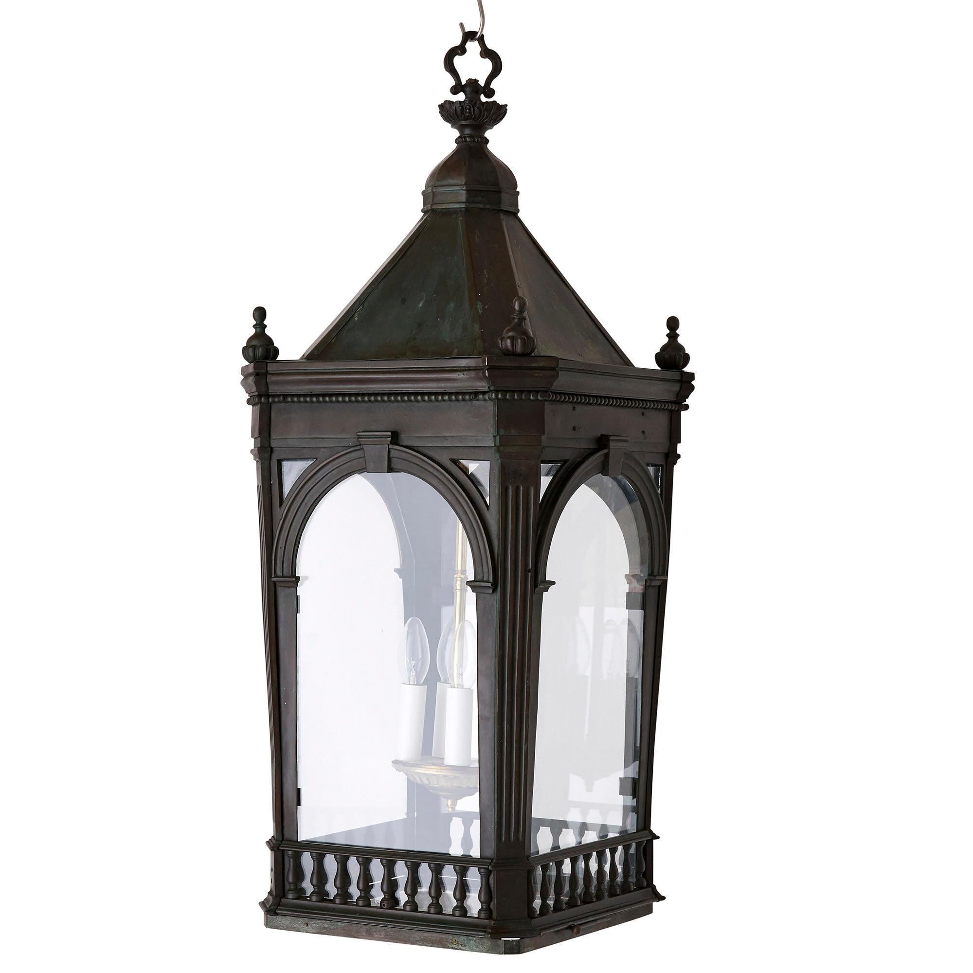 Antique architectural Victorian period brass four-light lantern
English, late 19th century
Dimensions: Height 94cm, width 39cm, depth 39cm

Finely crafted from patinated brass and glass, this four-light lantern is architecturally designed in the