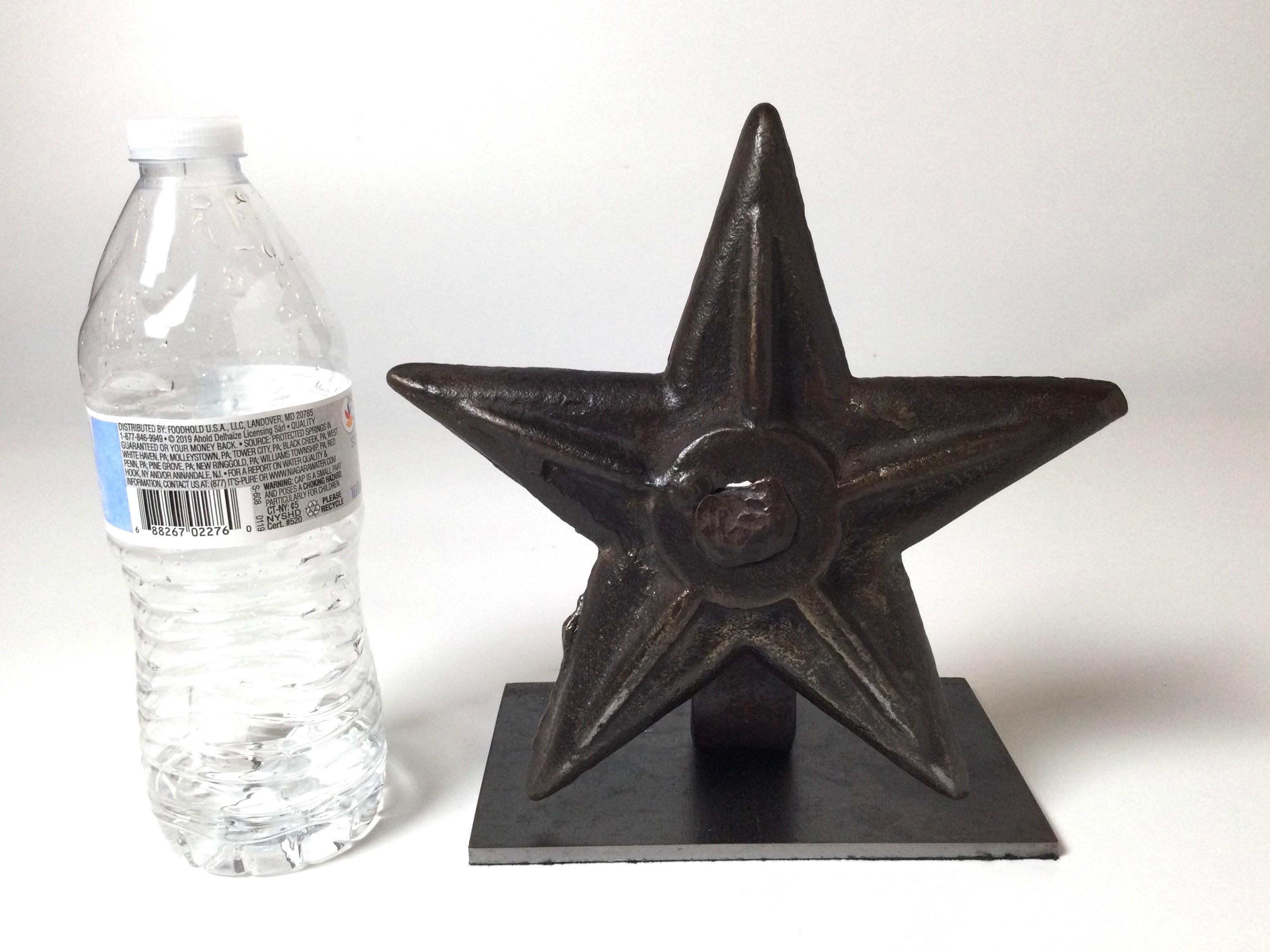 An iron architectural building star anchor mounted on a steel base. The 19th Century star is originally part of a brick building and used to anchor in to secure the brickwork to the interior beams. This has been mounted to a professionally made