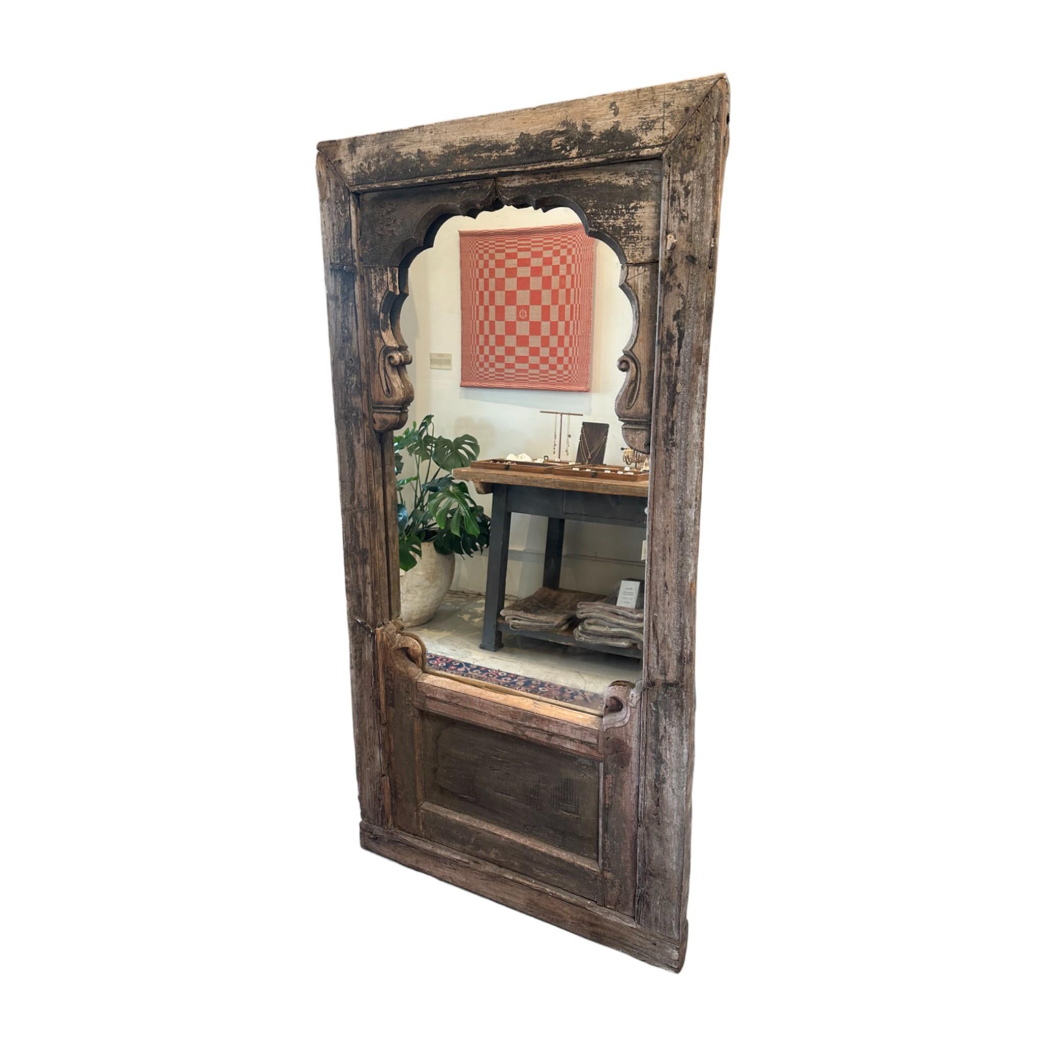 With its beautifully aged patina and intricate carved details, this Antique Archway Mirror brings old-world charm to any space. The grand wooden frame, rich with history, adds depth and character, making it a striking focal point. Perfect for