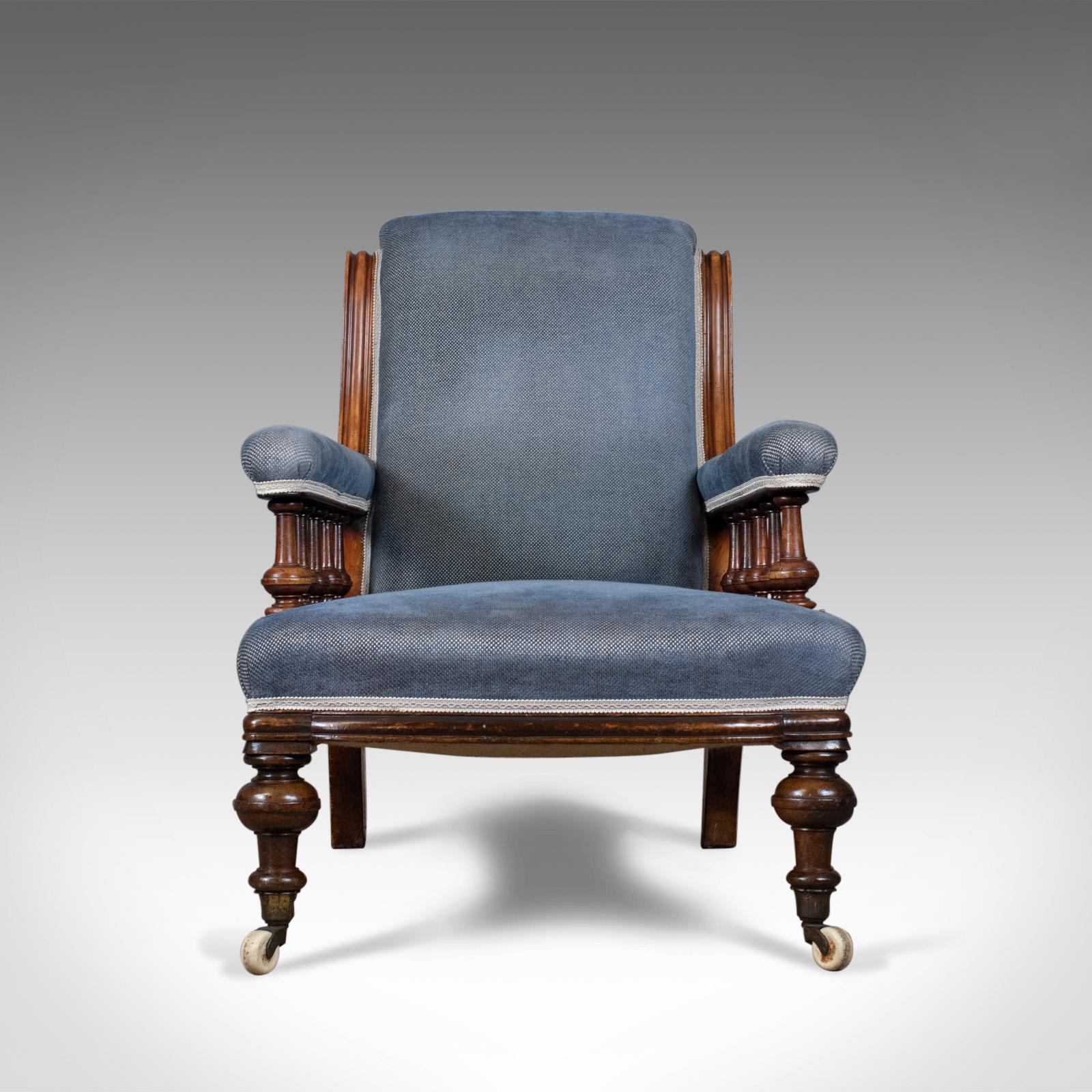 This is an antique armchair, an English, Victorian, club chair, walnut with blue upholstery, dating to the late 19th century, circa 1880.

Walnut framed offering a comfortable, deep seat
Raised on turned legs to the front and swept square section