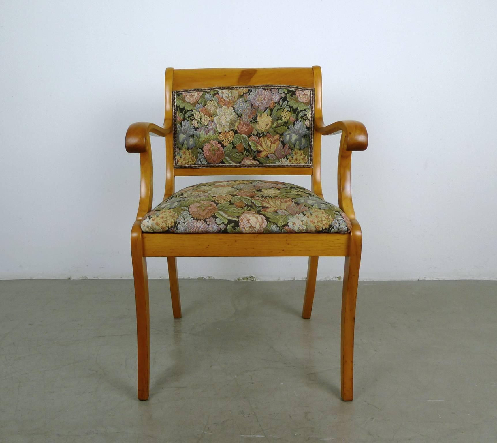 Armchair with solid cherry frame and colored fabric cover with plant motifs. The backrest is covered on both sides with fabric. Curved armrests close at the front in a snail shape.
This armchair was made circa 1900 in Southern Germany in